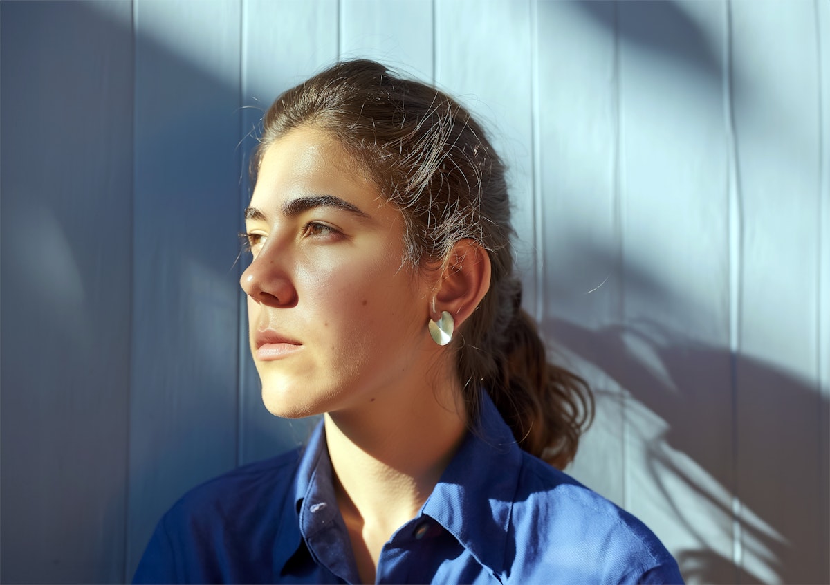 Contemplative woman's profile in natural light.