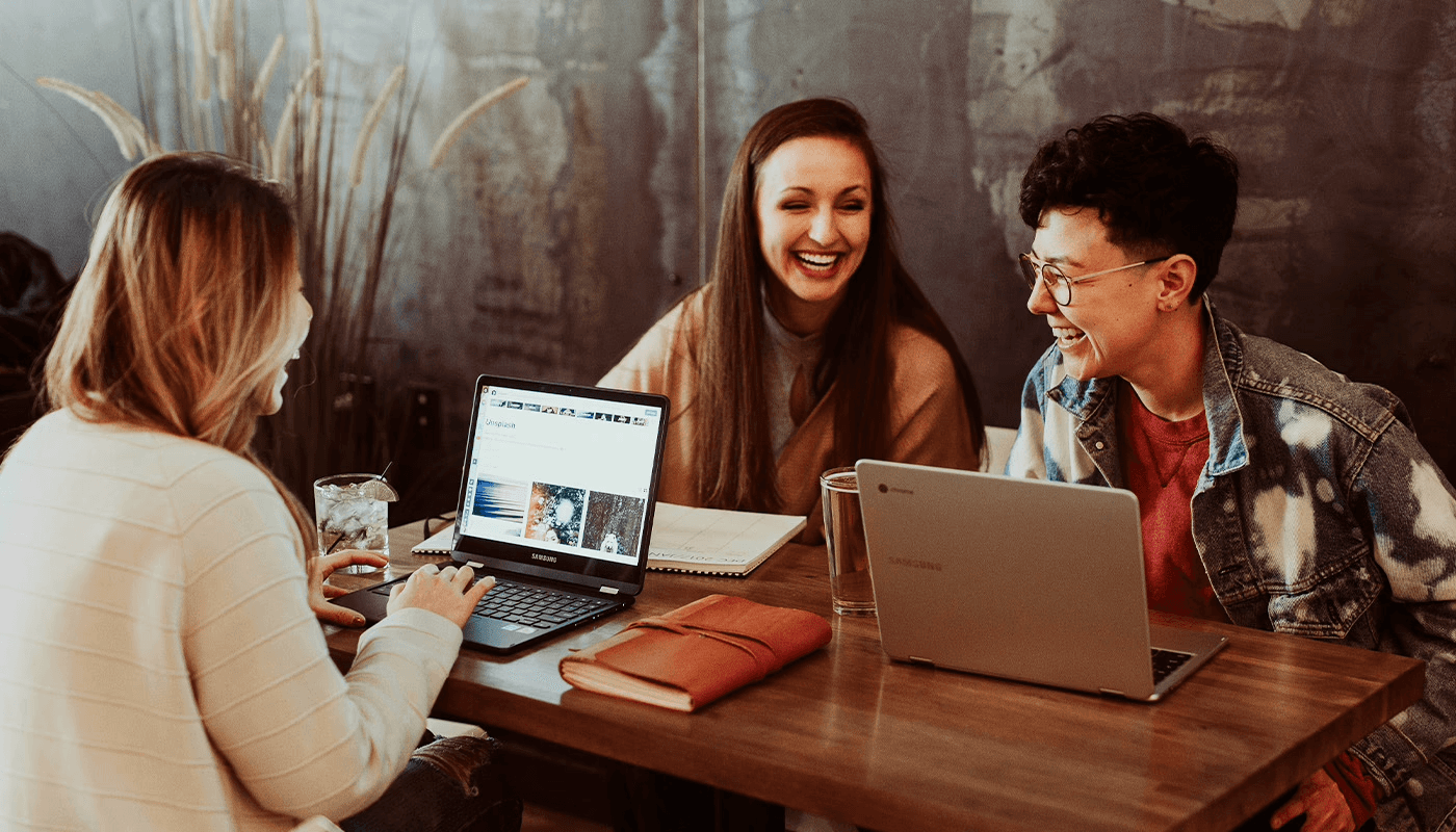 Colleagues chatting over their laptop