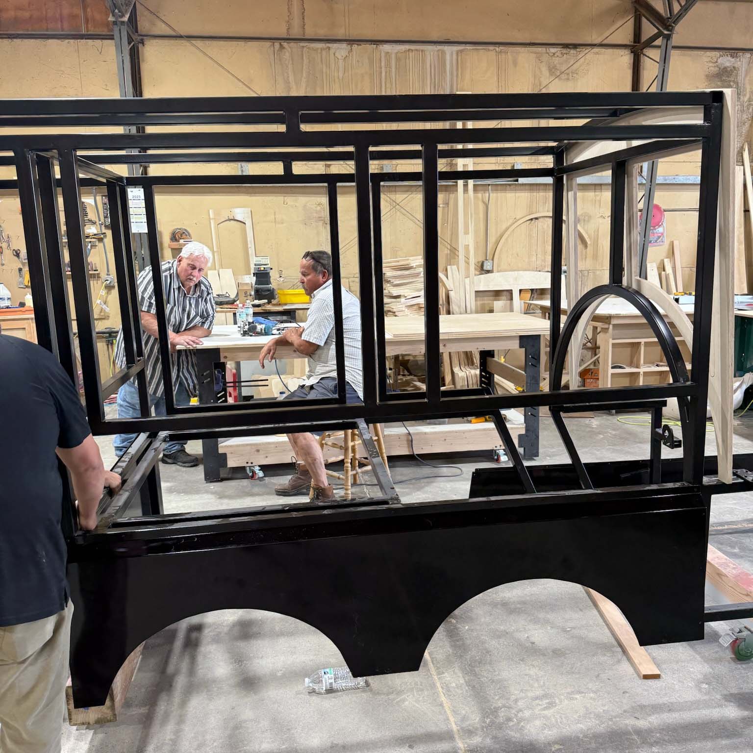 Workers working on train in shop