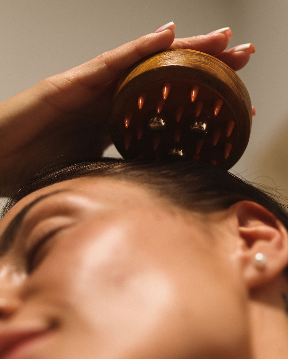 A close-up of hands performing a relaxing massage, with warm golden light illuminating the skin. The scene evokes a sense of relaxation and well-being.