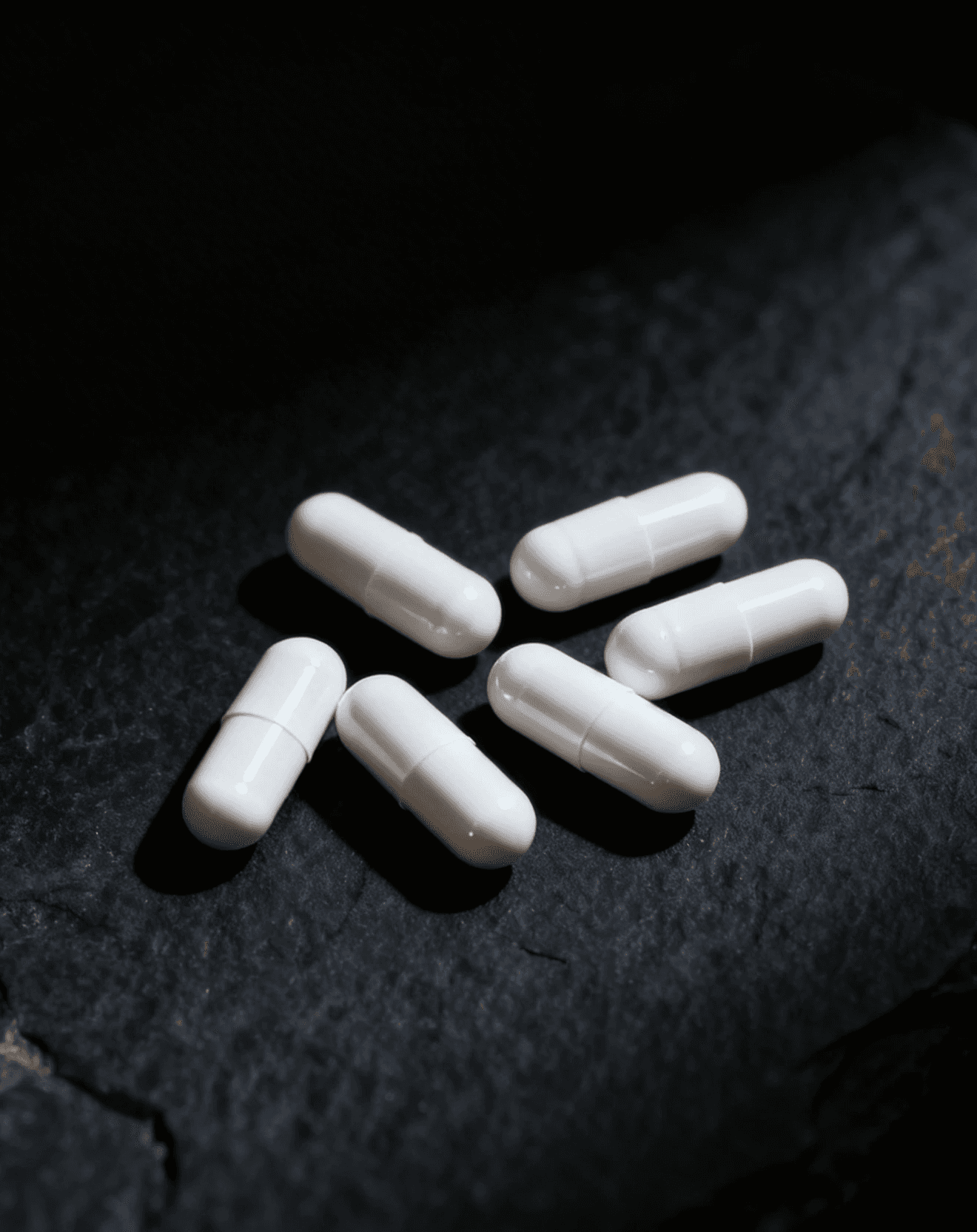 white bills on dark stone