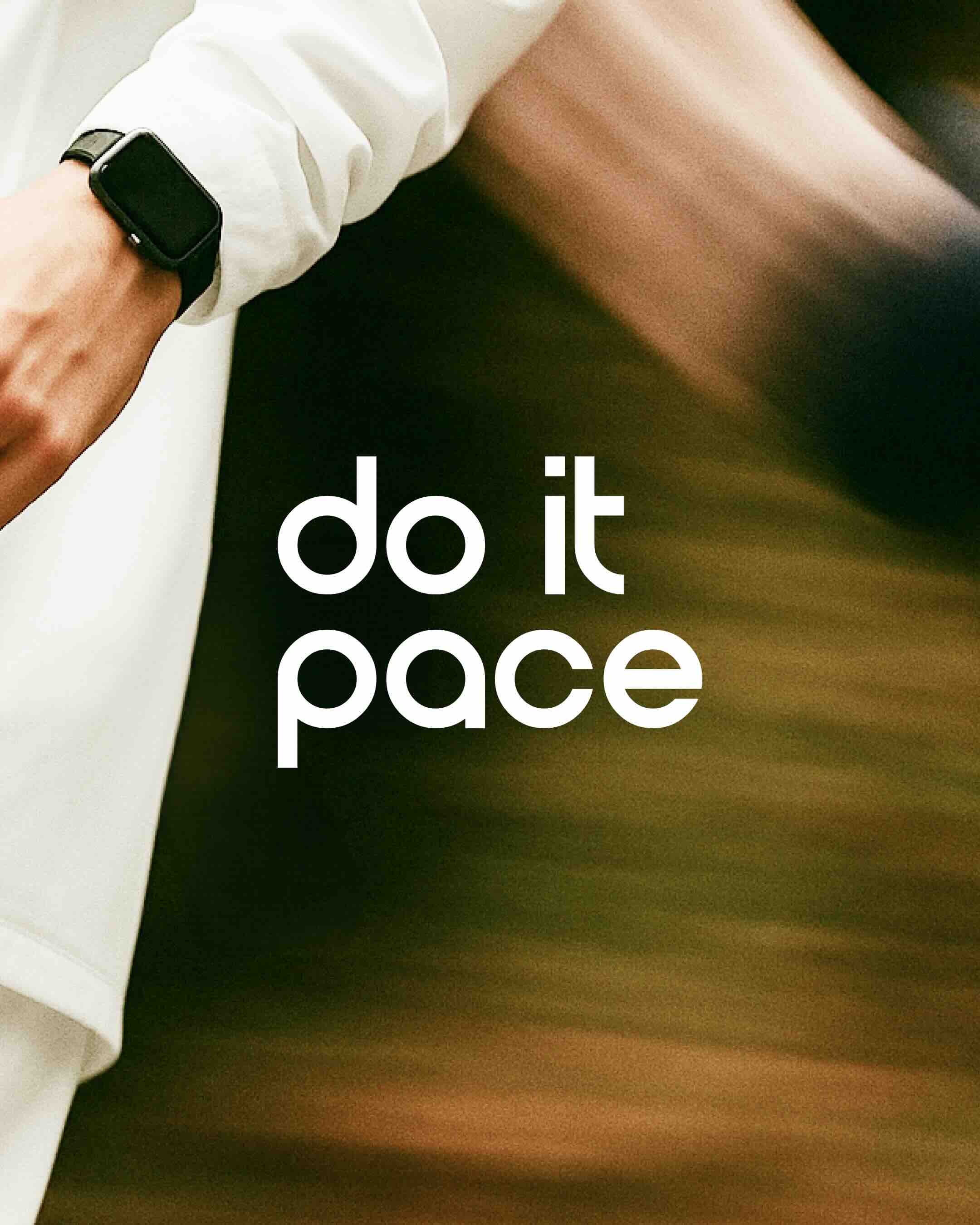 Elegant hand against a red background wearing two gold bracelets, one sleek and minimal, the other a delicate chain.