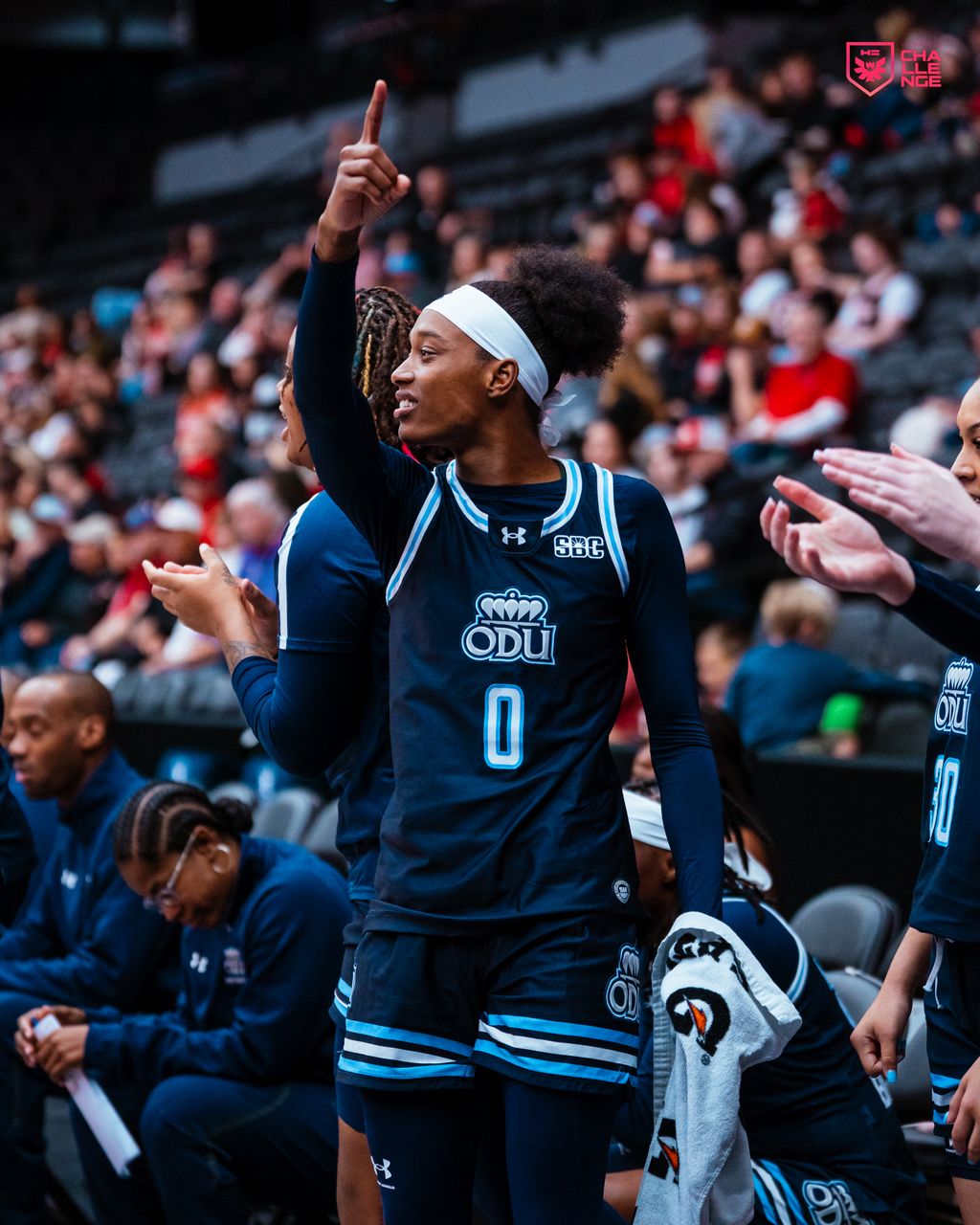 Three people sitting on a couch in a room looking at mobile devices