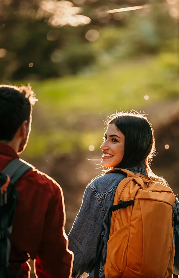 Woman looking at her partner with a sunny backdrop on a beautiful Summer day.