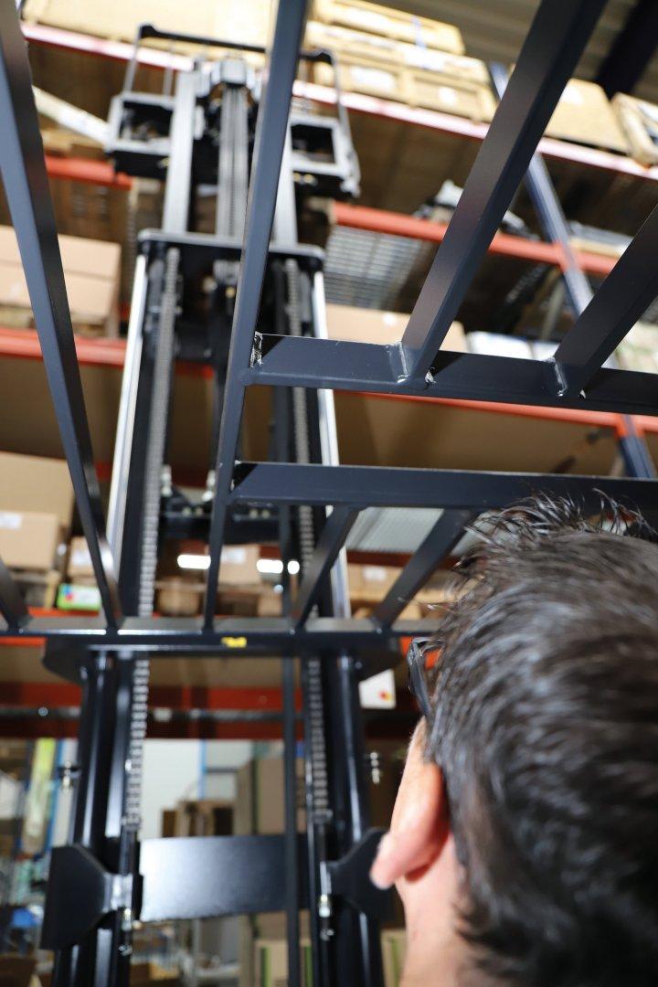 Forklift driver stacking shelves in a warehouse