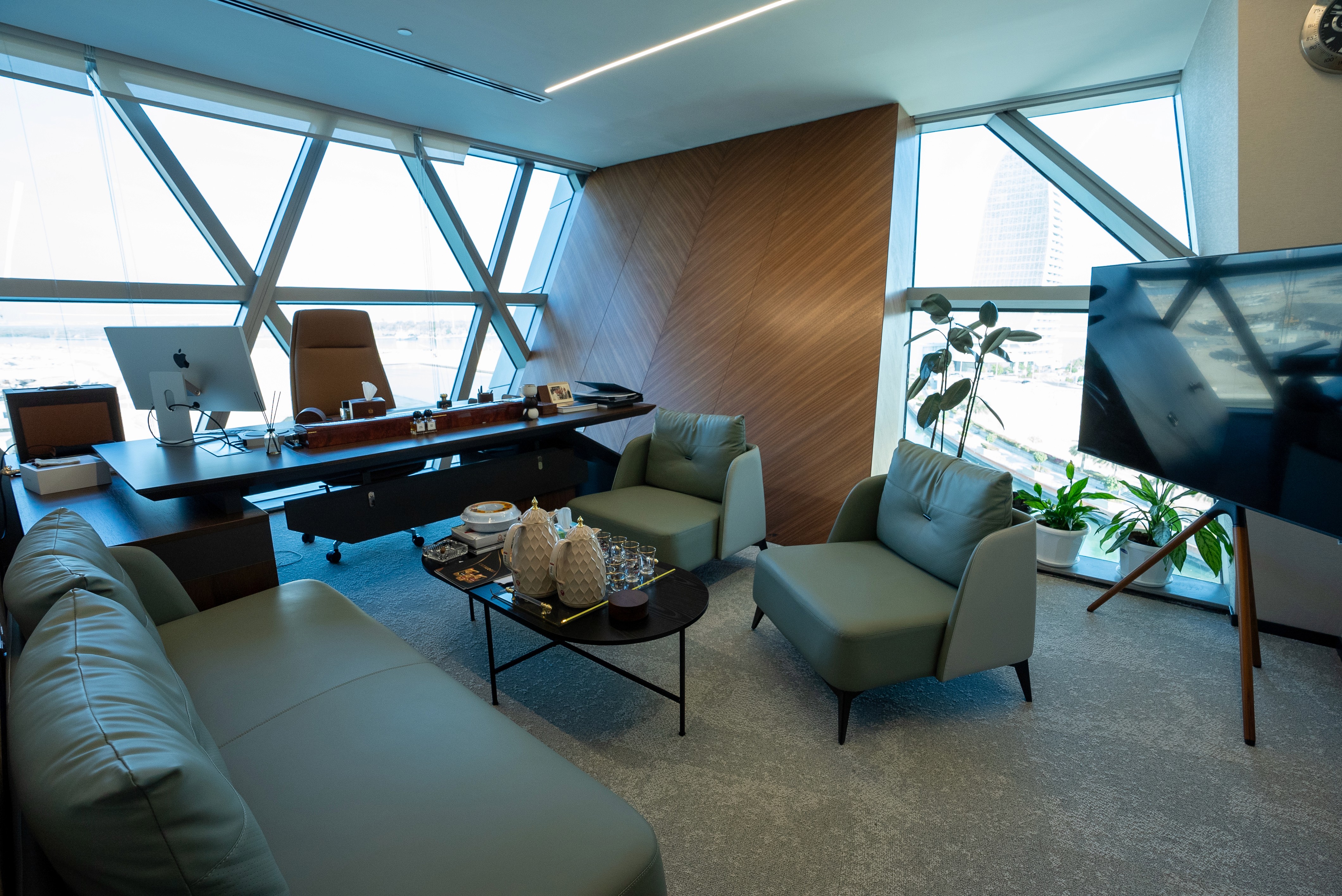 Luxurious executive office space in Abu Dhabi with natural light, soft seating, and panoramic city views, ideal for private meetings.
