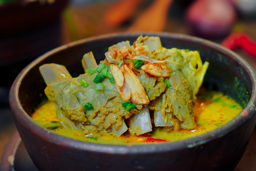 two glass of iced tea with some orange fruit around them