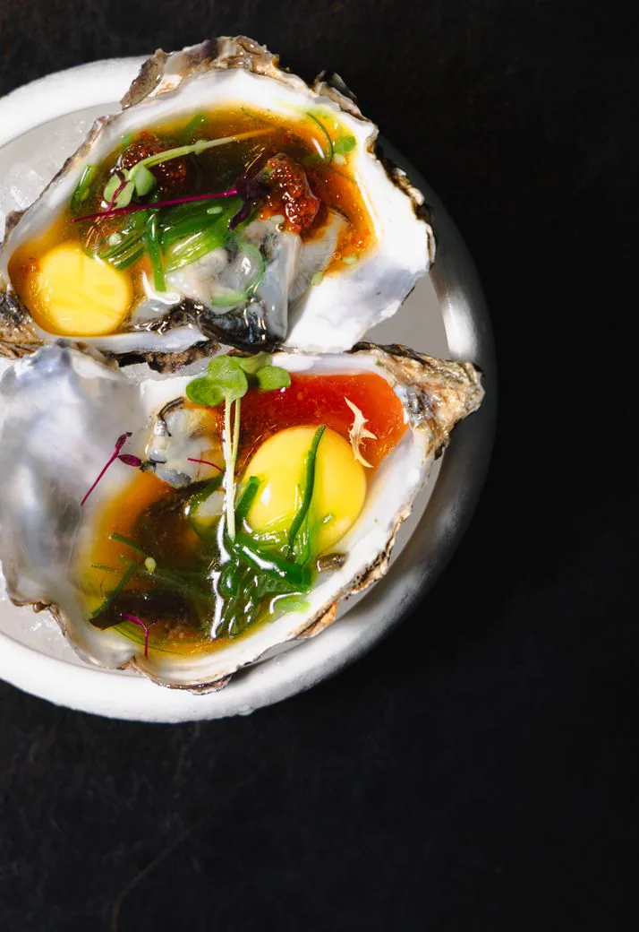 Topped oysters served in their shells