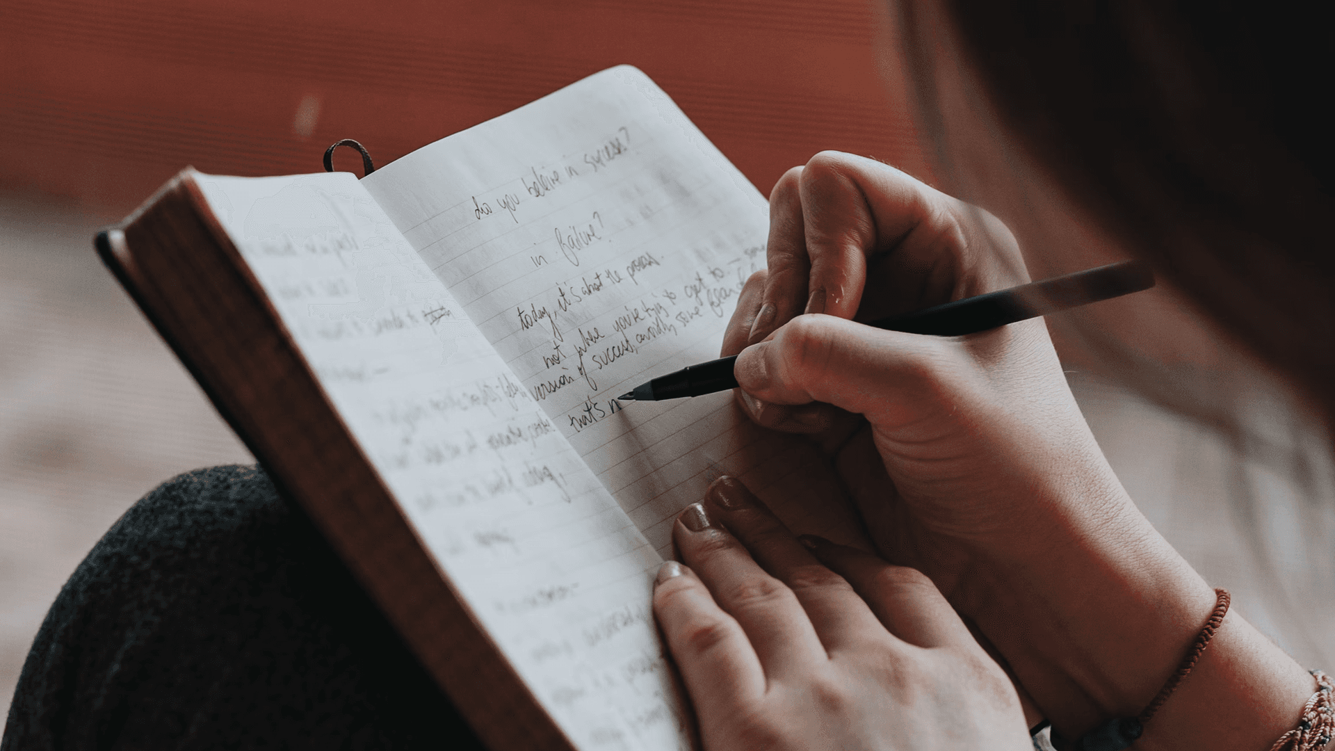 Person journaling in a notebook as a screen-free mindfulness practice.