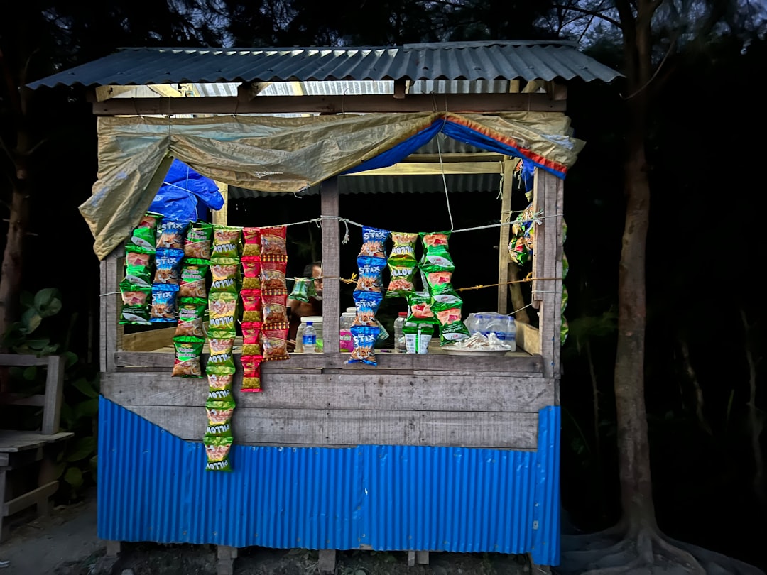 a small shop with a blue awning and a blue awning