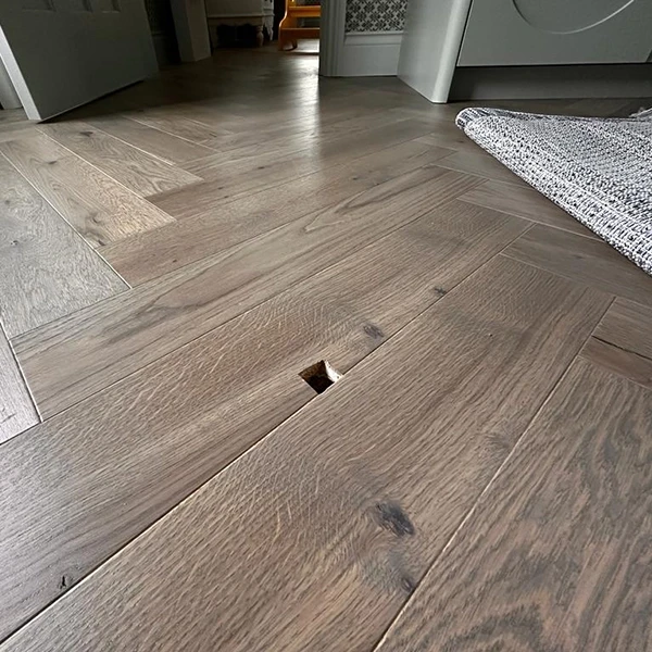 Scratched engineered wood flooring before repair in Dubai