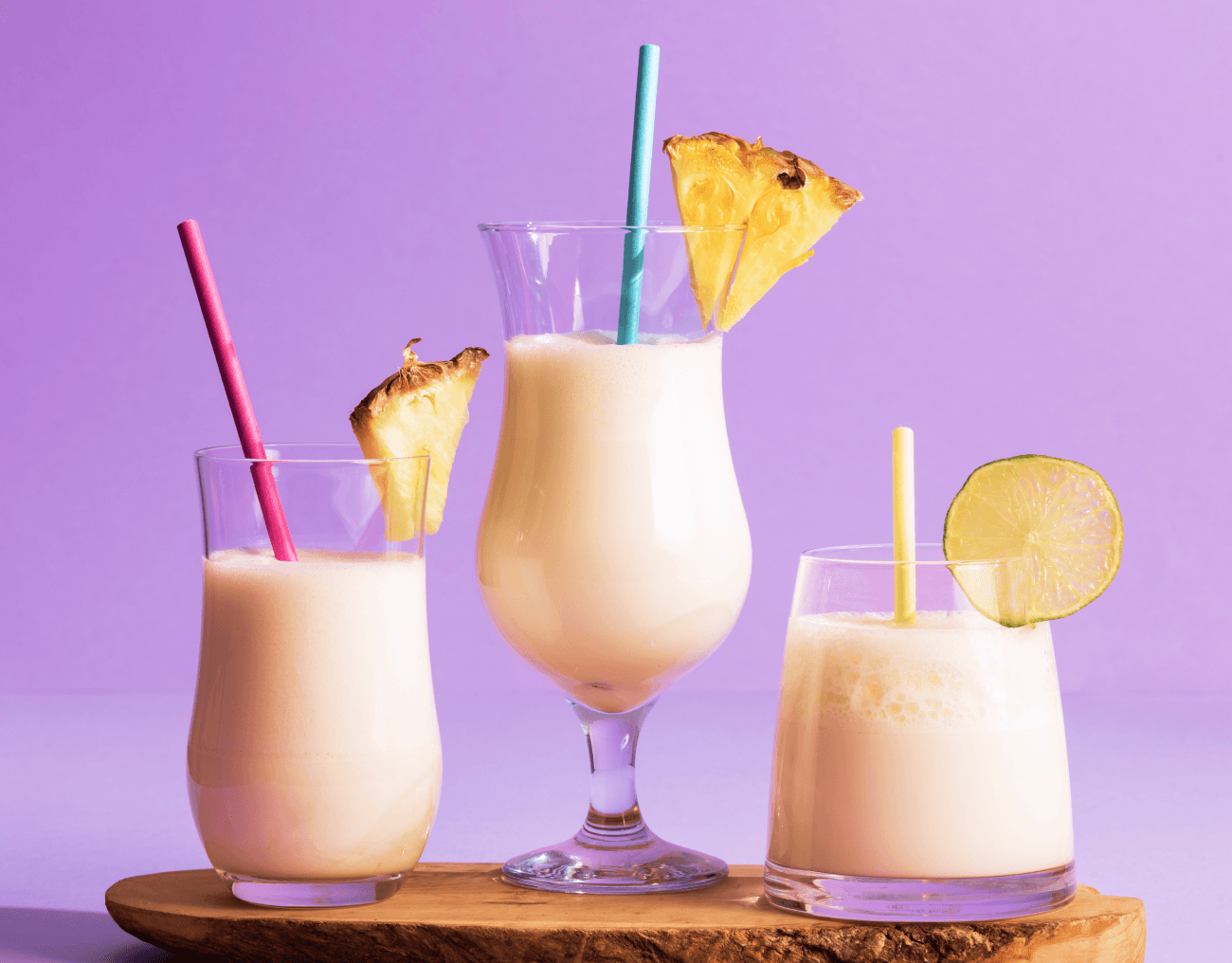three smoothies with purple background