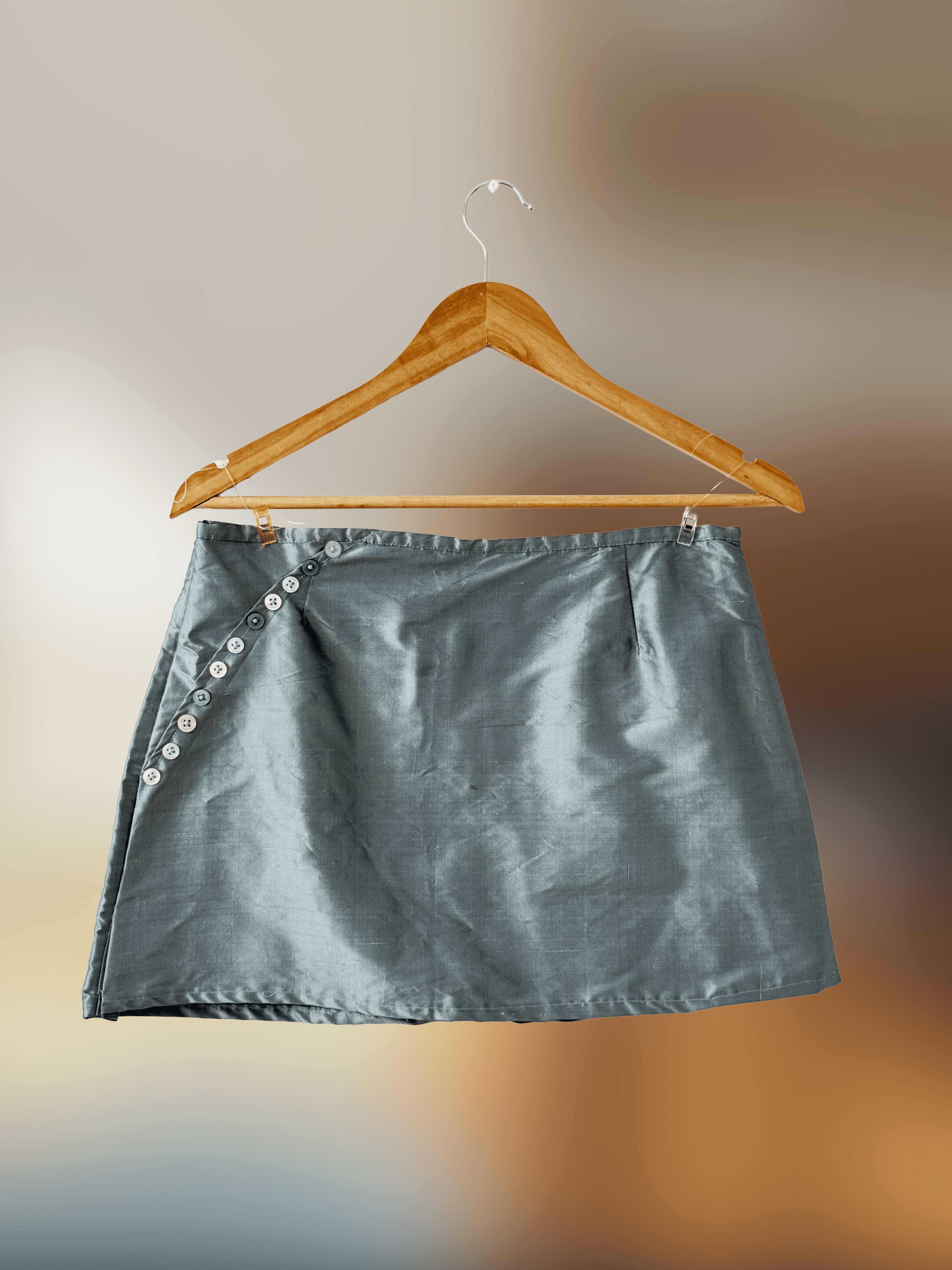 Front of metallic blue mini skirt with button detail