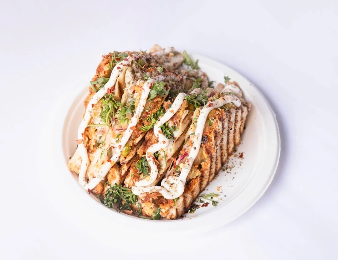 a white plate topped with a pile of food