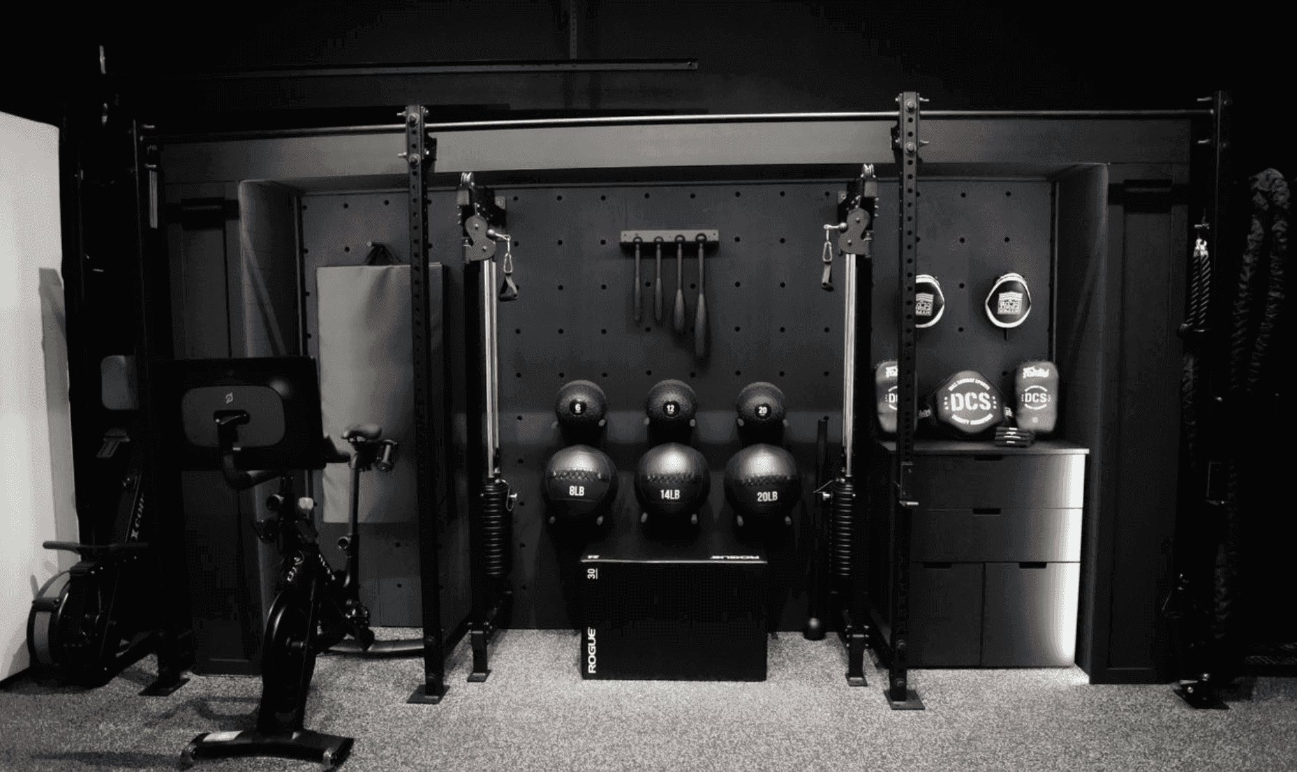 Custom garage home gym featuring functional trainers, wall-mounted storage, and strength equipment as part of Custom Home Gym Builds Canada.