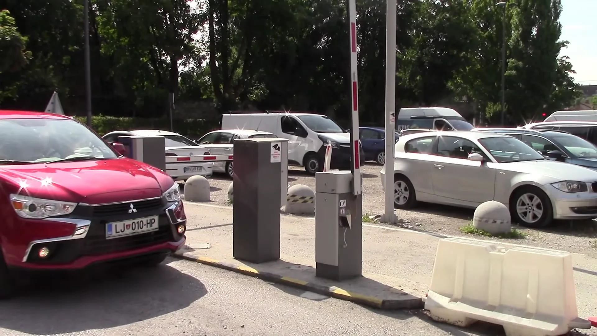 Original parking scene in Ljubljana, with vehicles entering and leaving a car park.