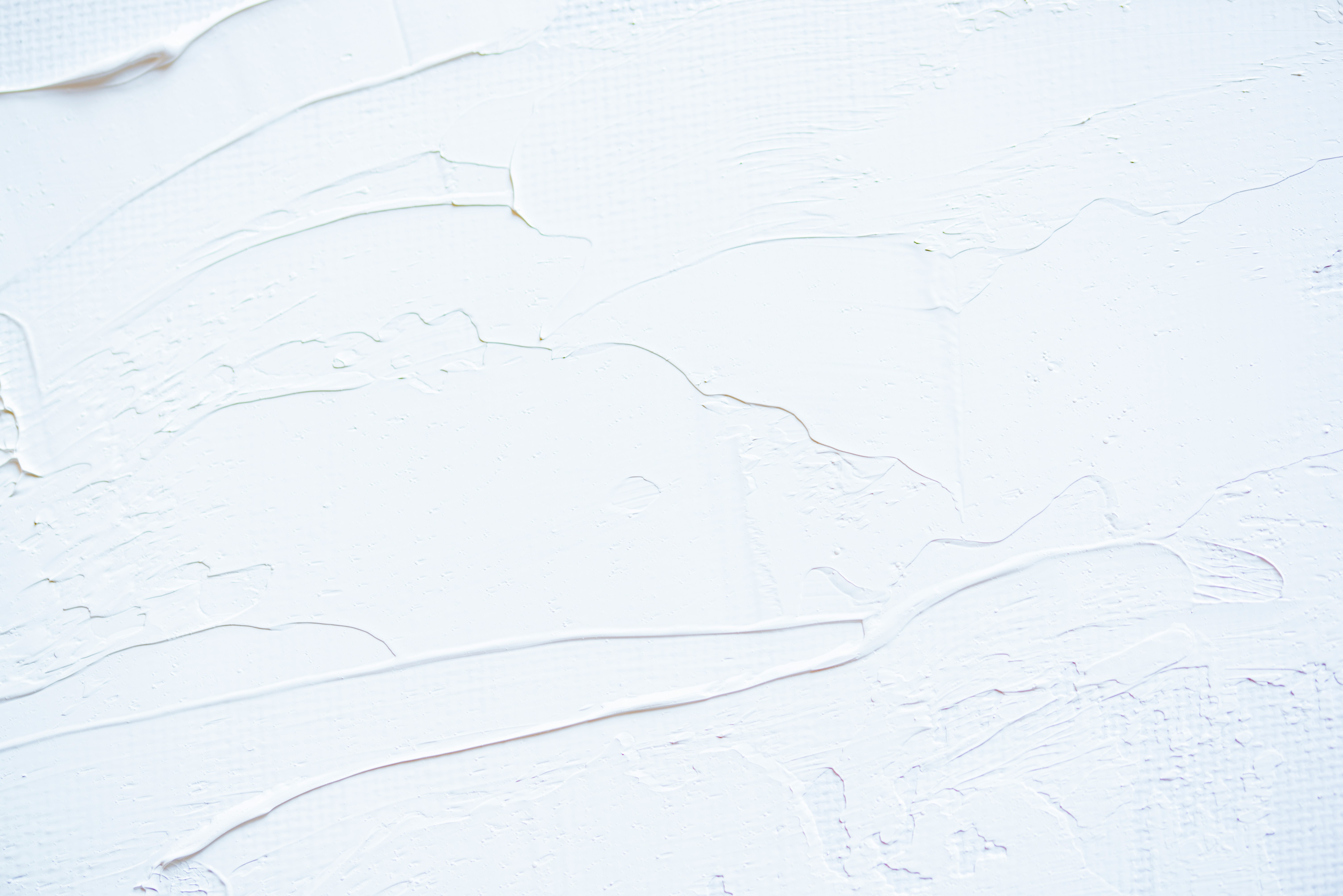 a close up of a white wall with peeling paint