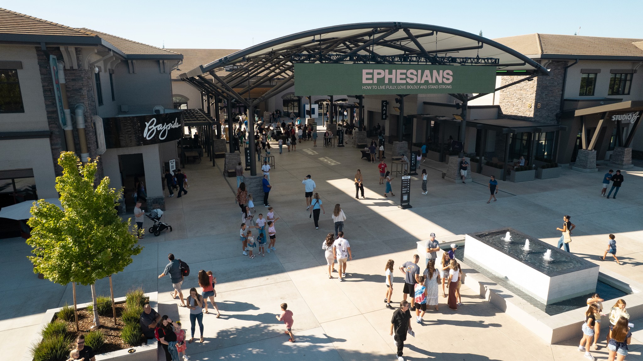 two people in a workspace working on their laptops 