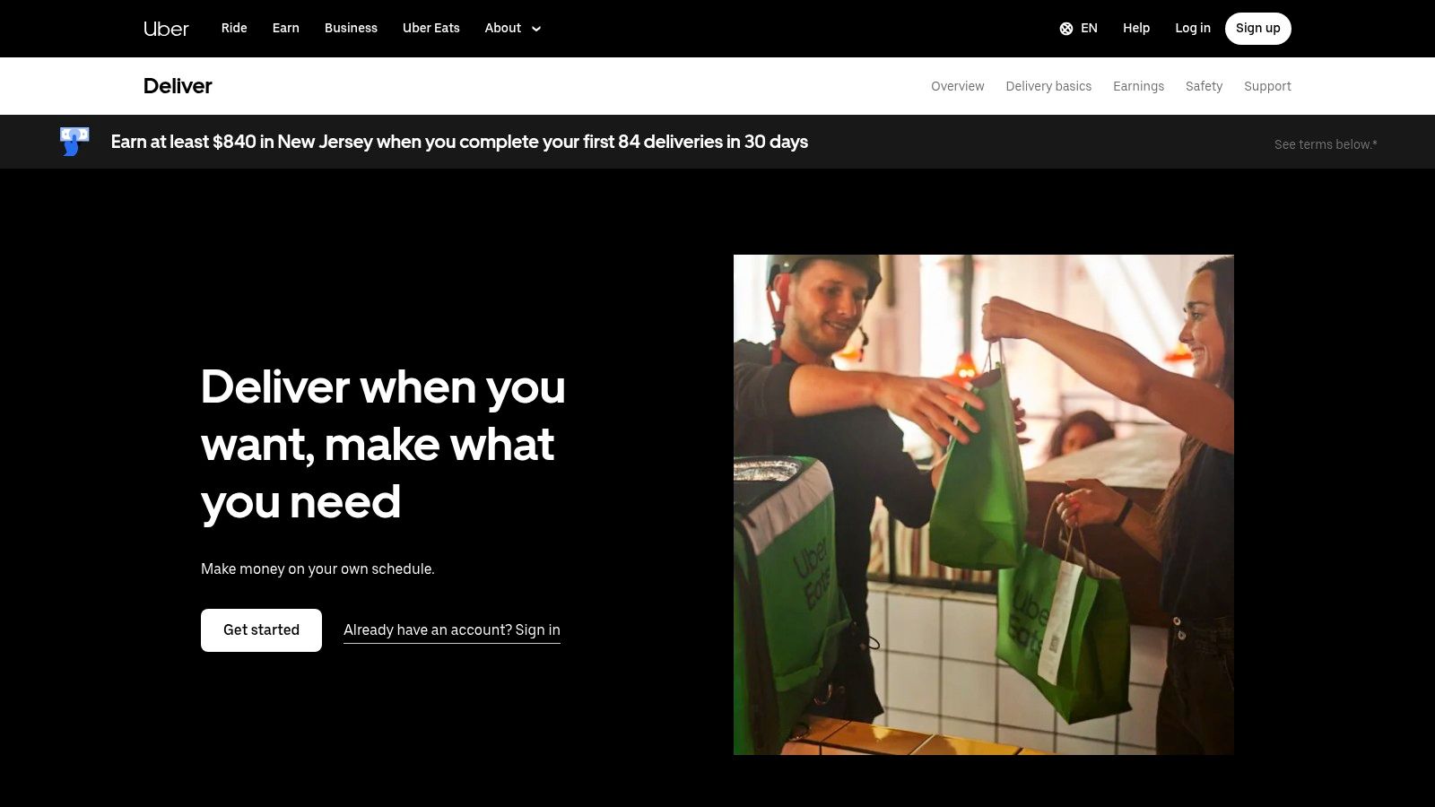 An Uber Eats delivery driver on a bicycle, representing side hustle apps in the UK.