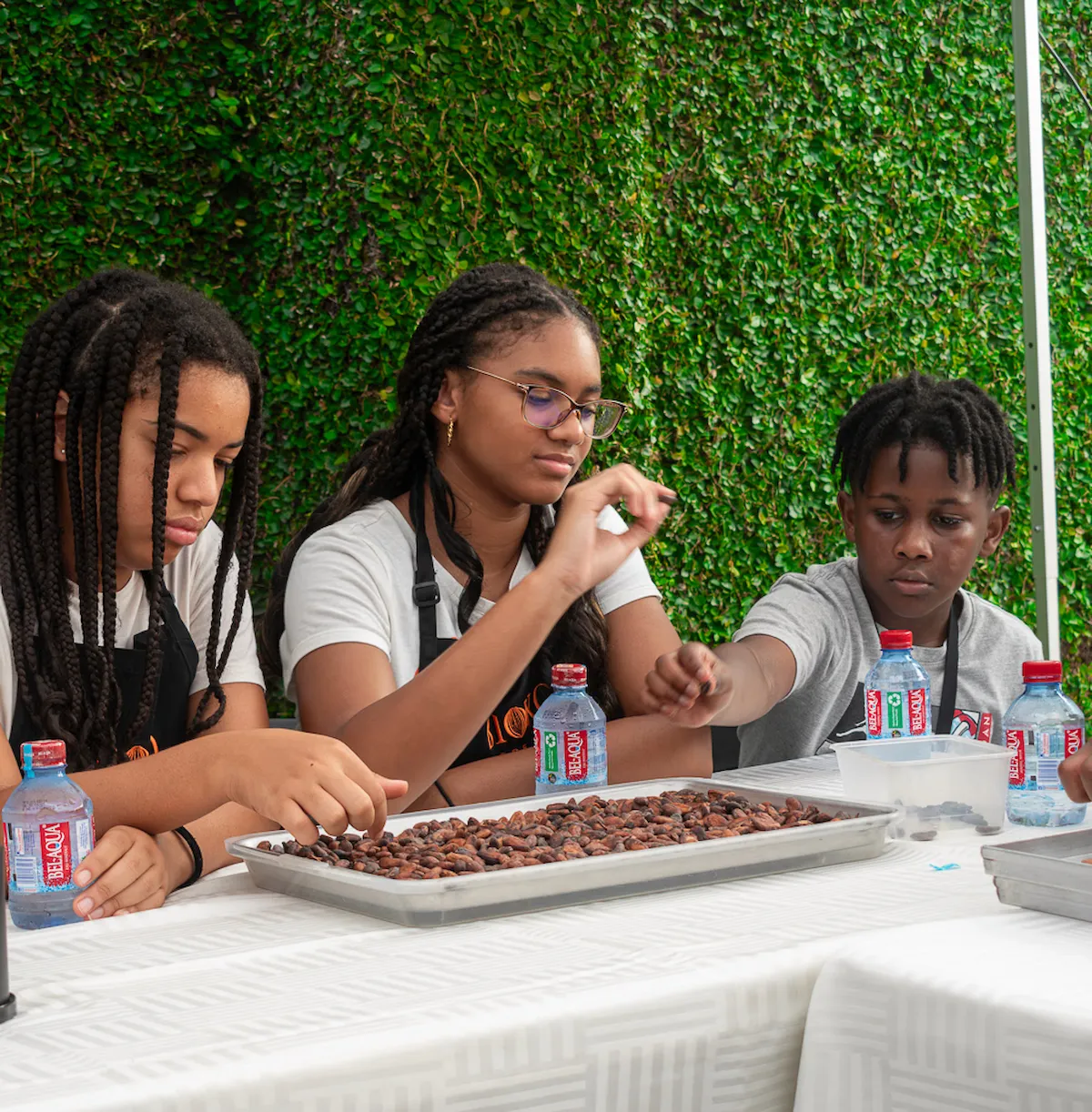 Young guests sorting fresh cocoa beans during a BookAfrica bean-to-bar chocolate workshop.
