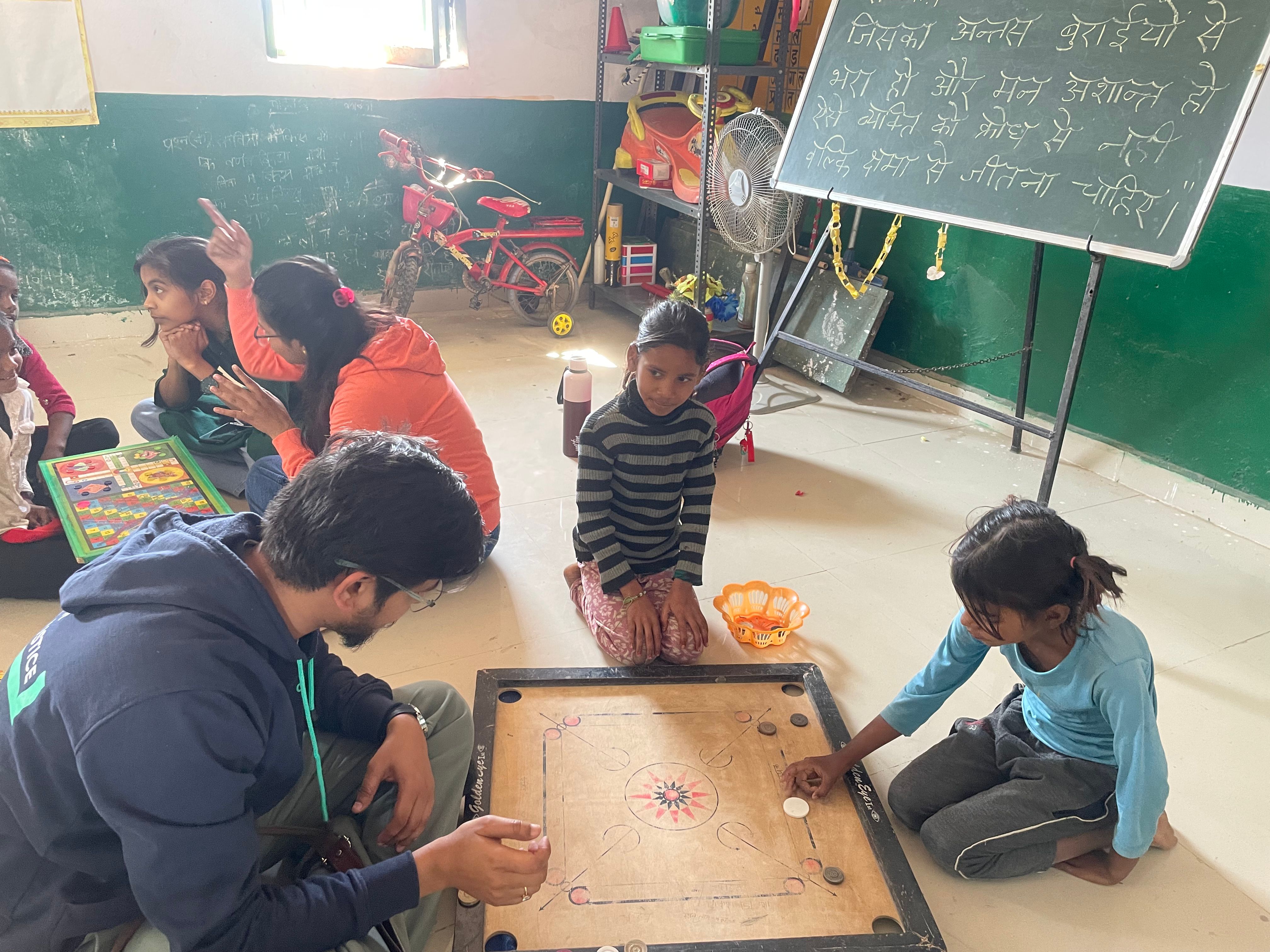 Engaging with young children through a game of carrom