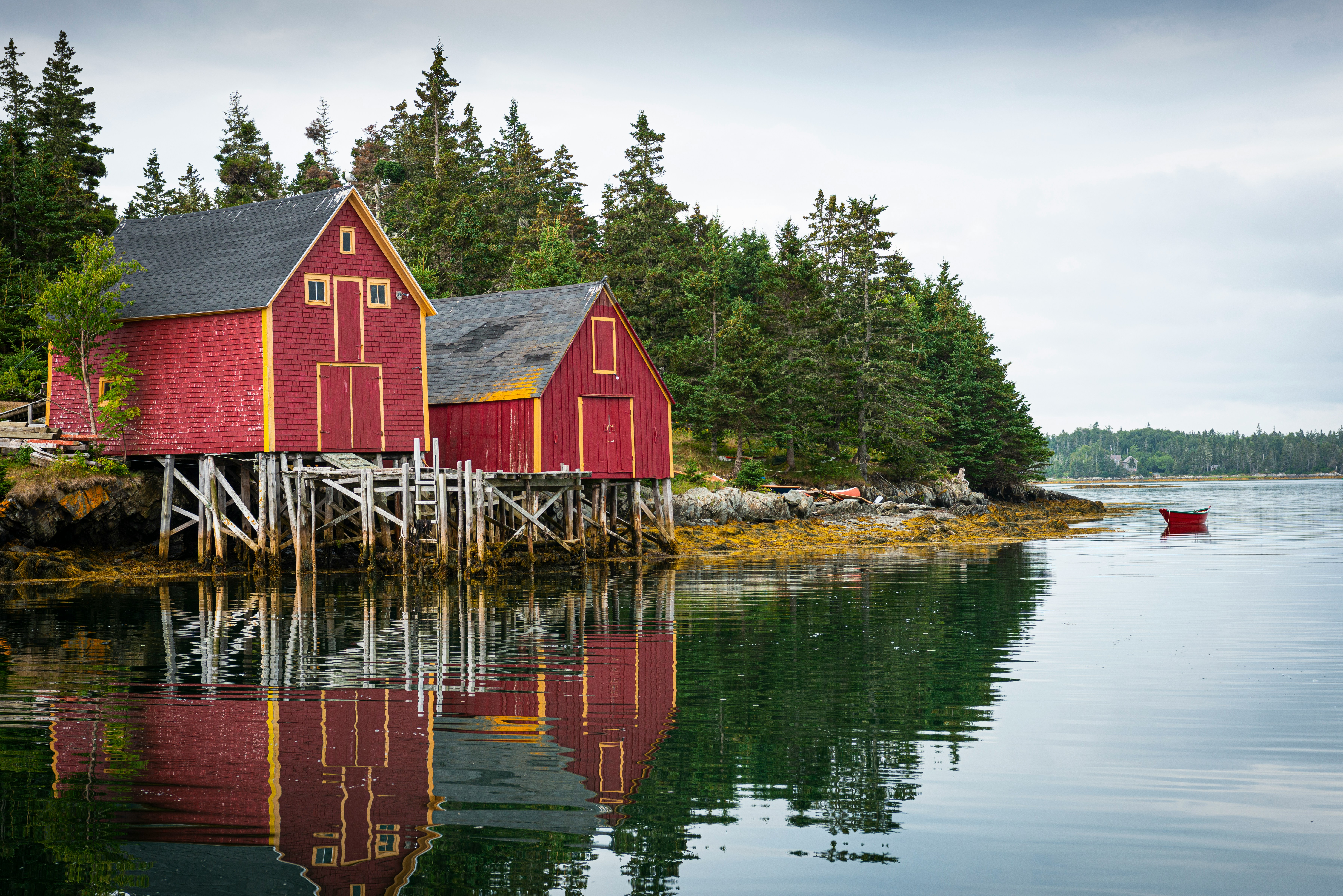 two red houses beside lake
