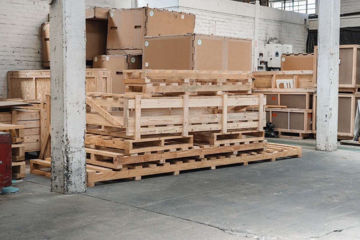 Stack of newly manufactured wooden pallets and custom crates.