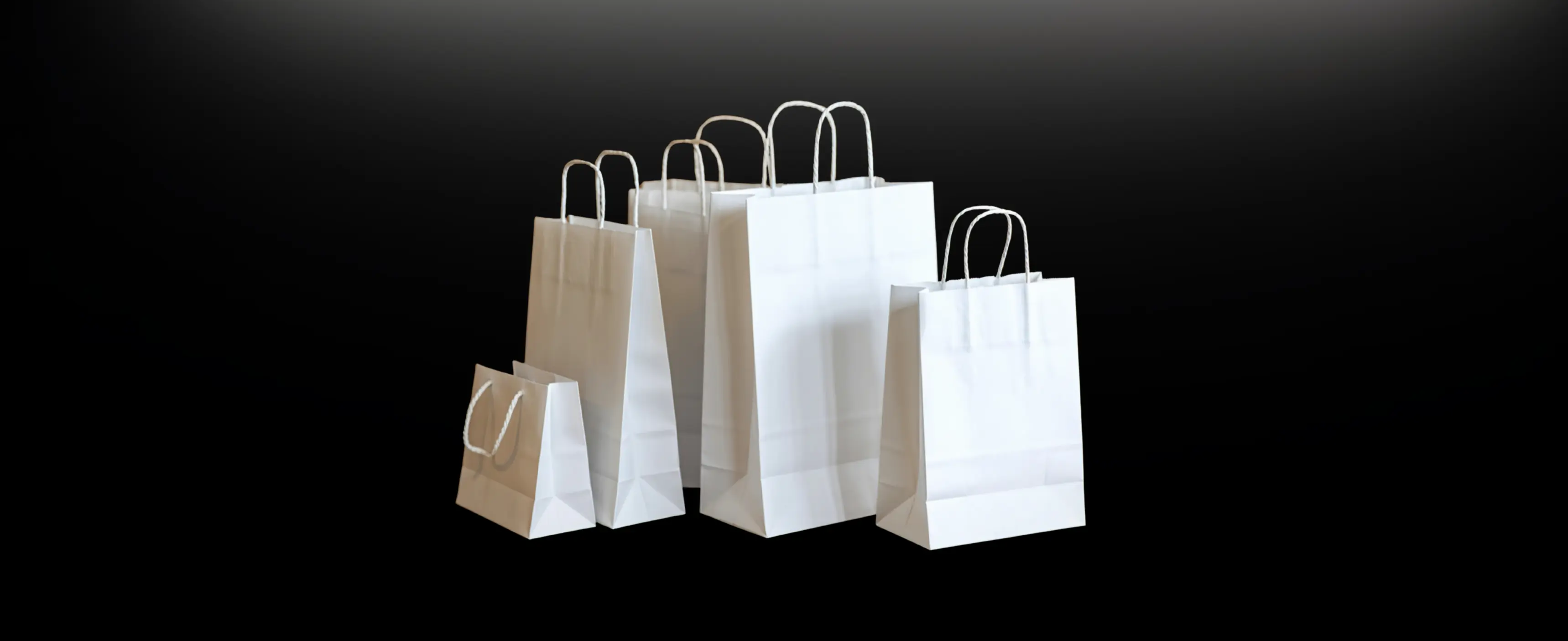 Aerial view of a winding road cutting through rocky terrain and sandy landscape.