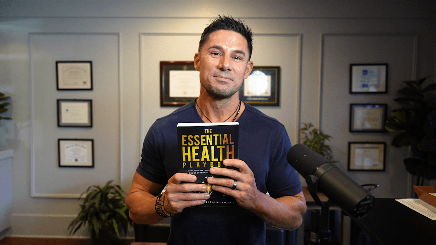 Two colleagues smiling while working together on a laptop.