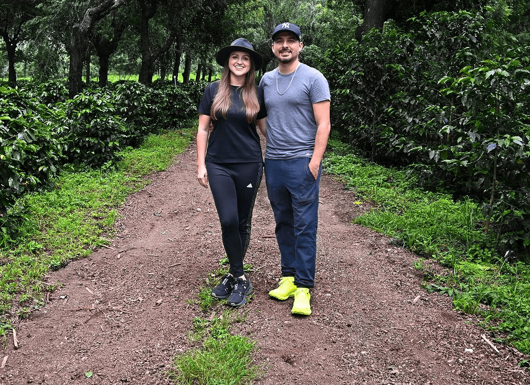 A couple in front of their coffee trees