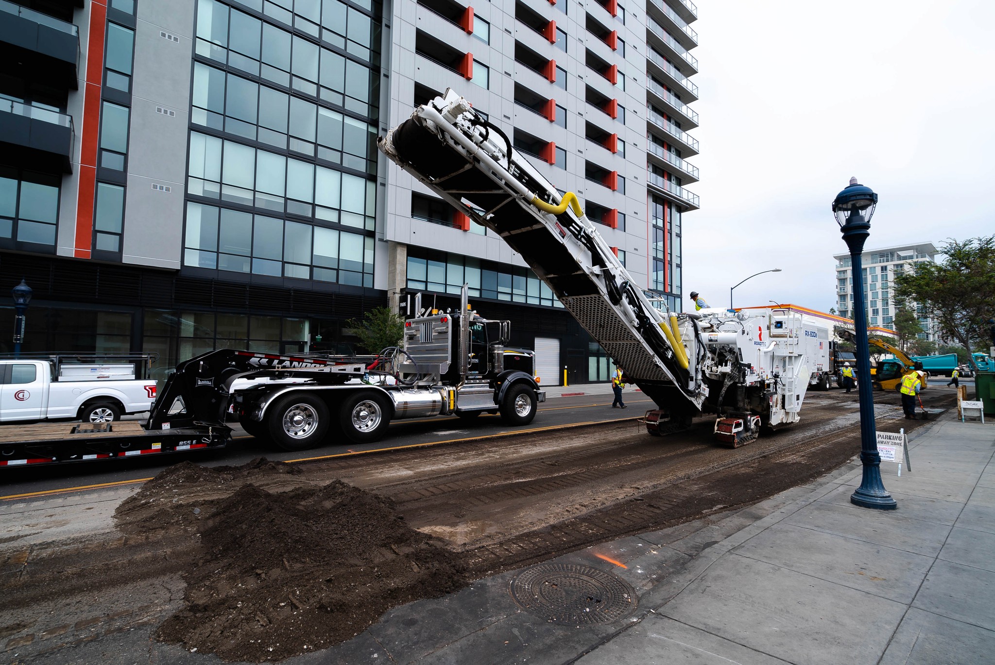 Asphalt milling machine grinding an asphalt road in downtown San Diego