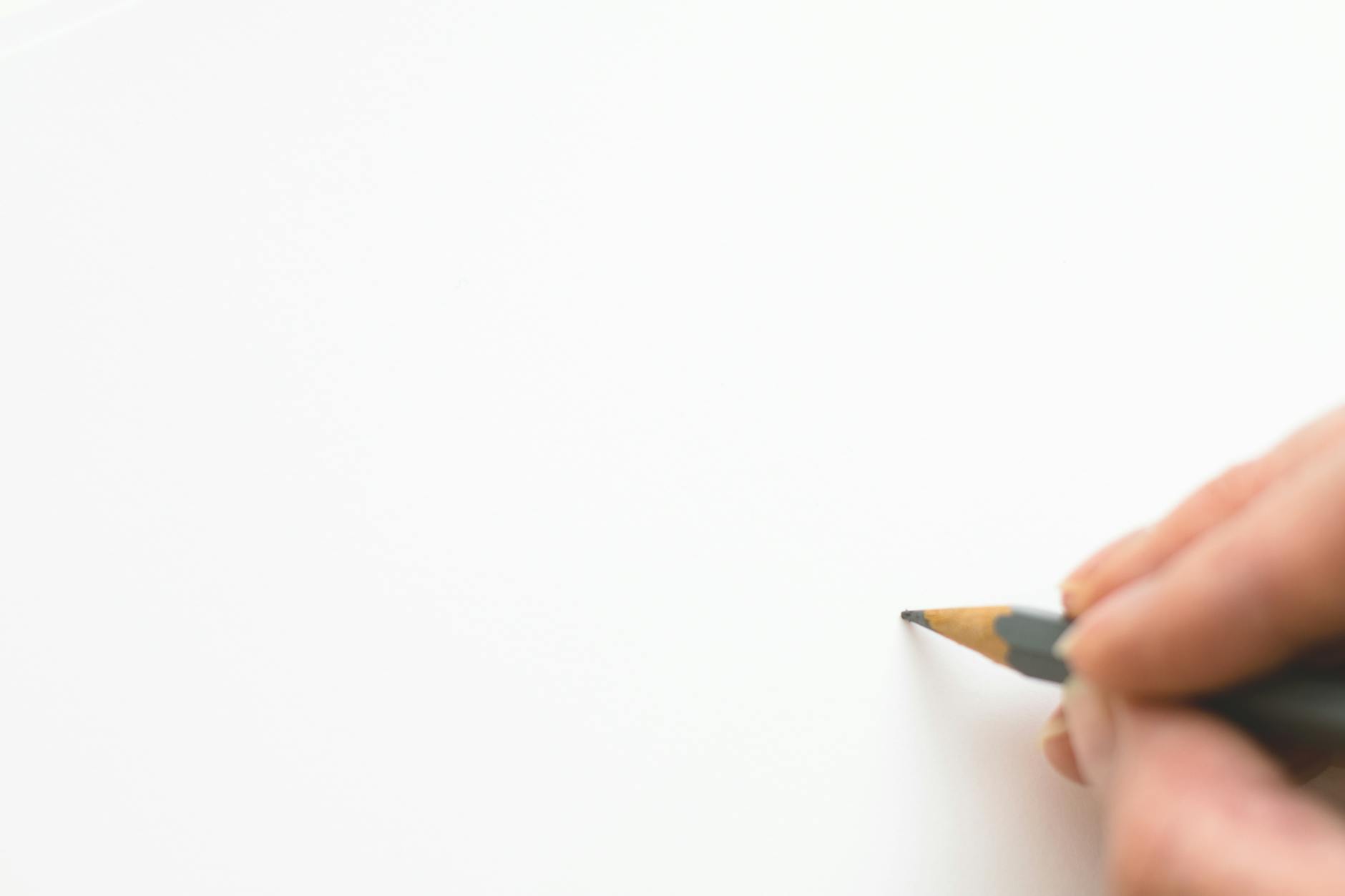 Close-up of a teacher's hands using a physical gesture to prompt a student before slowly pulling their hands away.