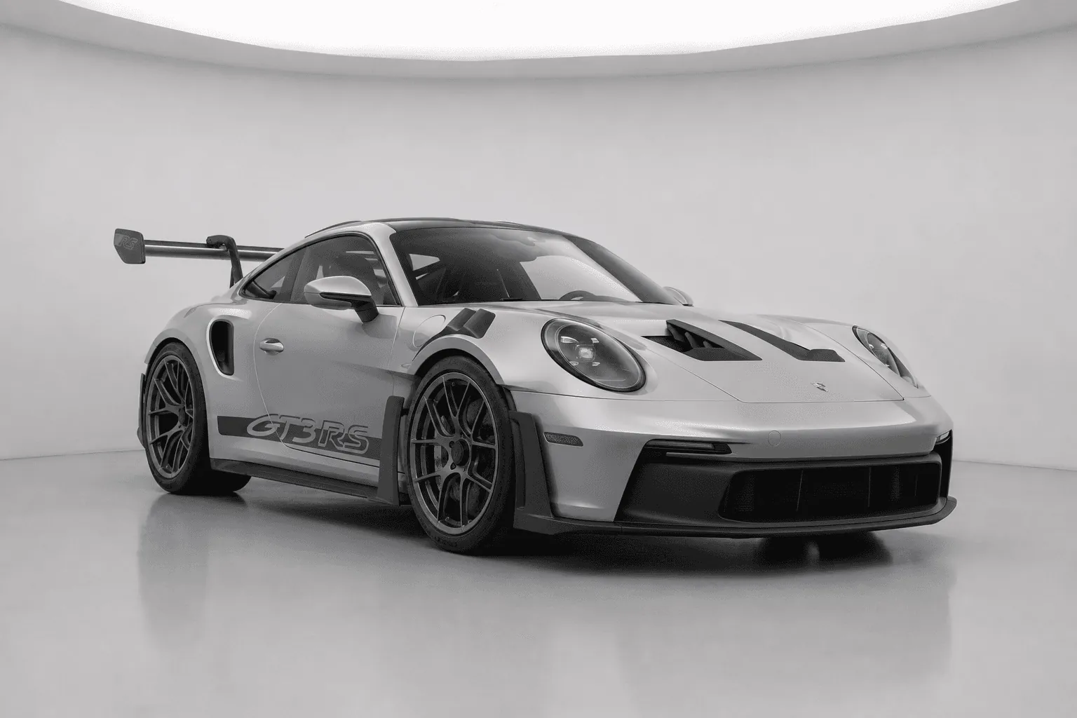 Silver Porsche GT3 RS with large rear wing and diffuser