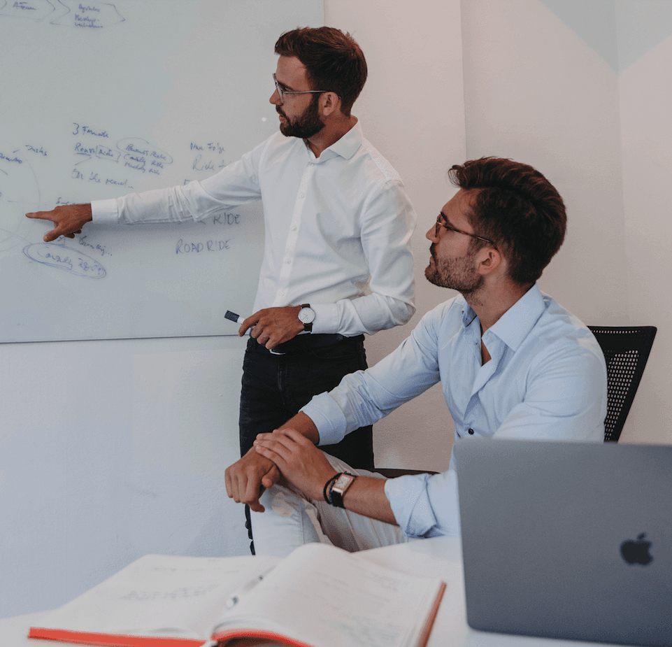 A young person with long, wavy hair sits in front of a plain background, looking directly at the camera.