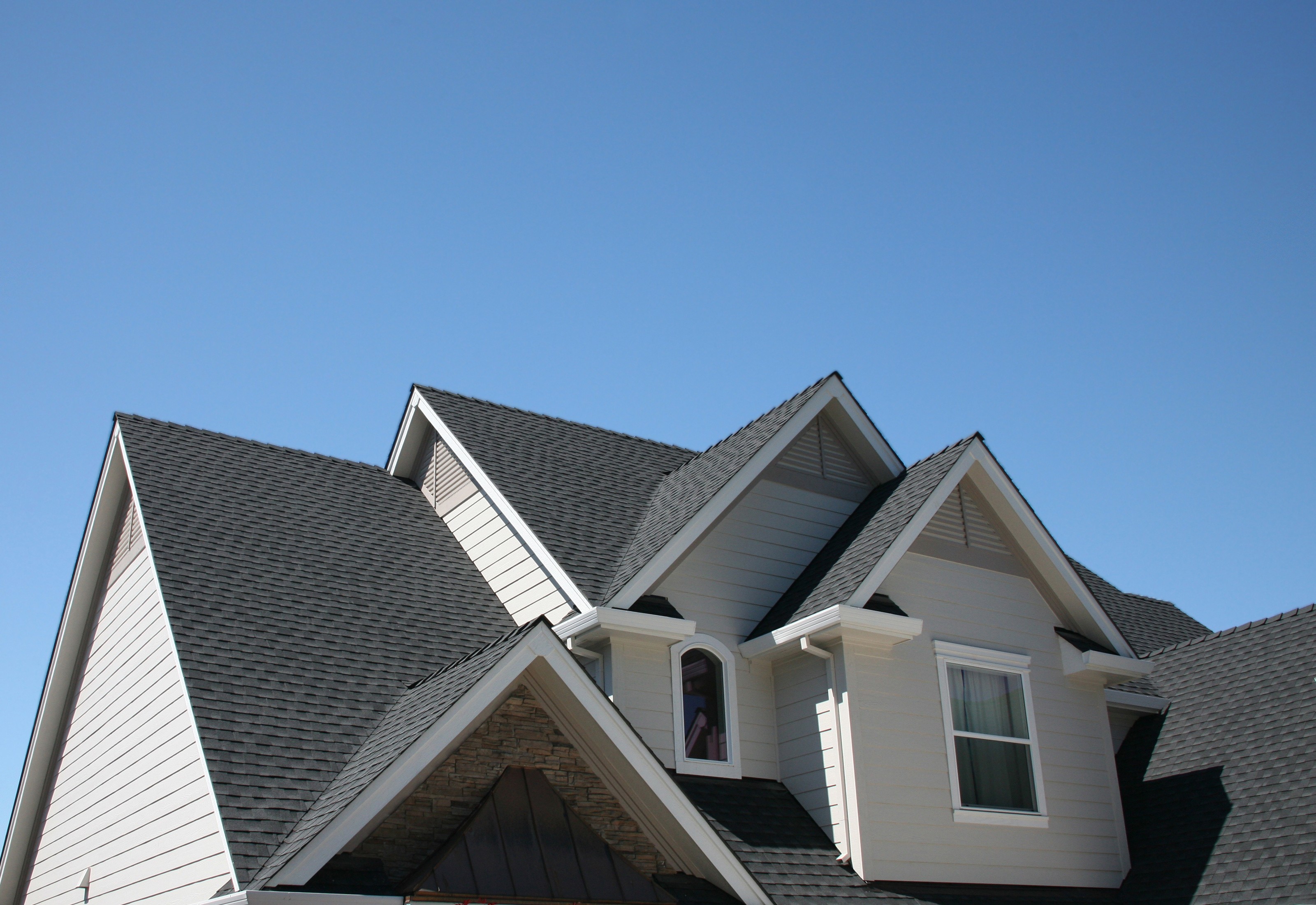 Quality roofing companies in St. Louis completed asphalt shingle installation on modern residential home