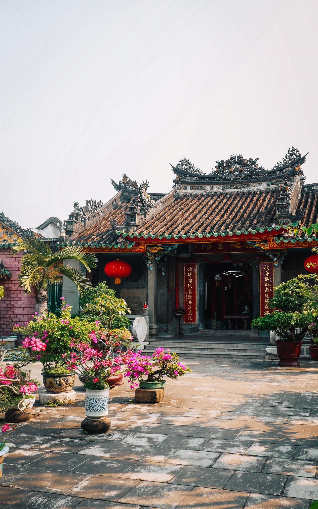 A red temple with flowers in front