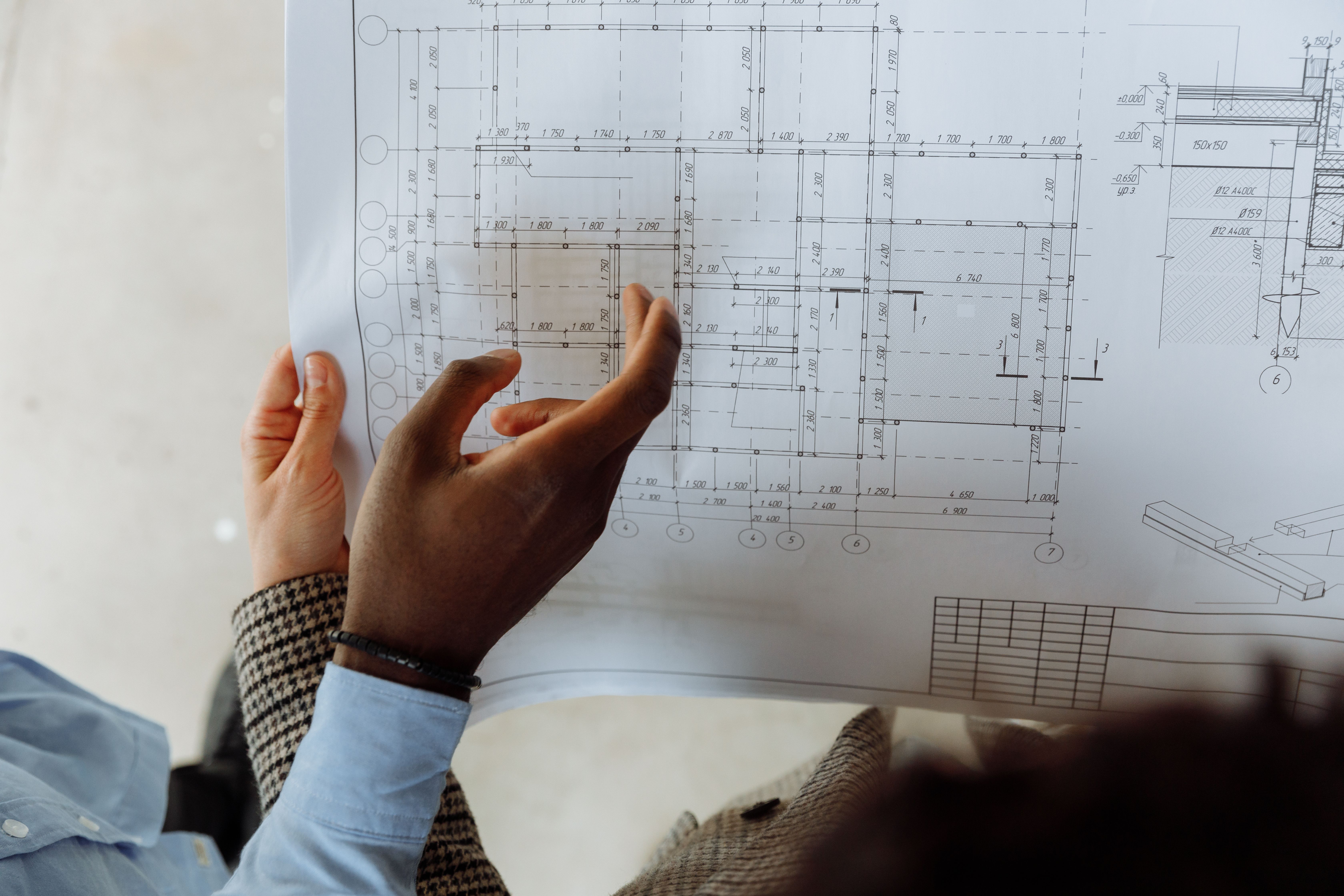 Consultant pointing to details on an architectural plan