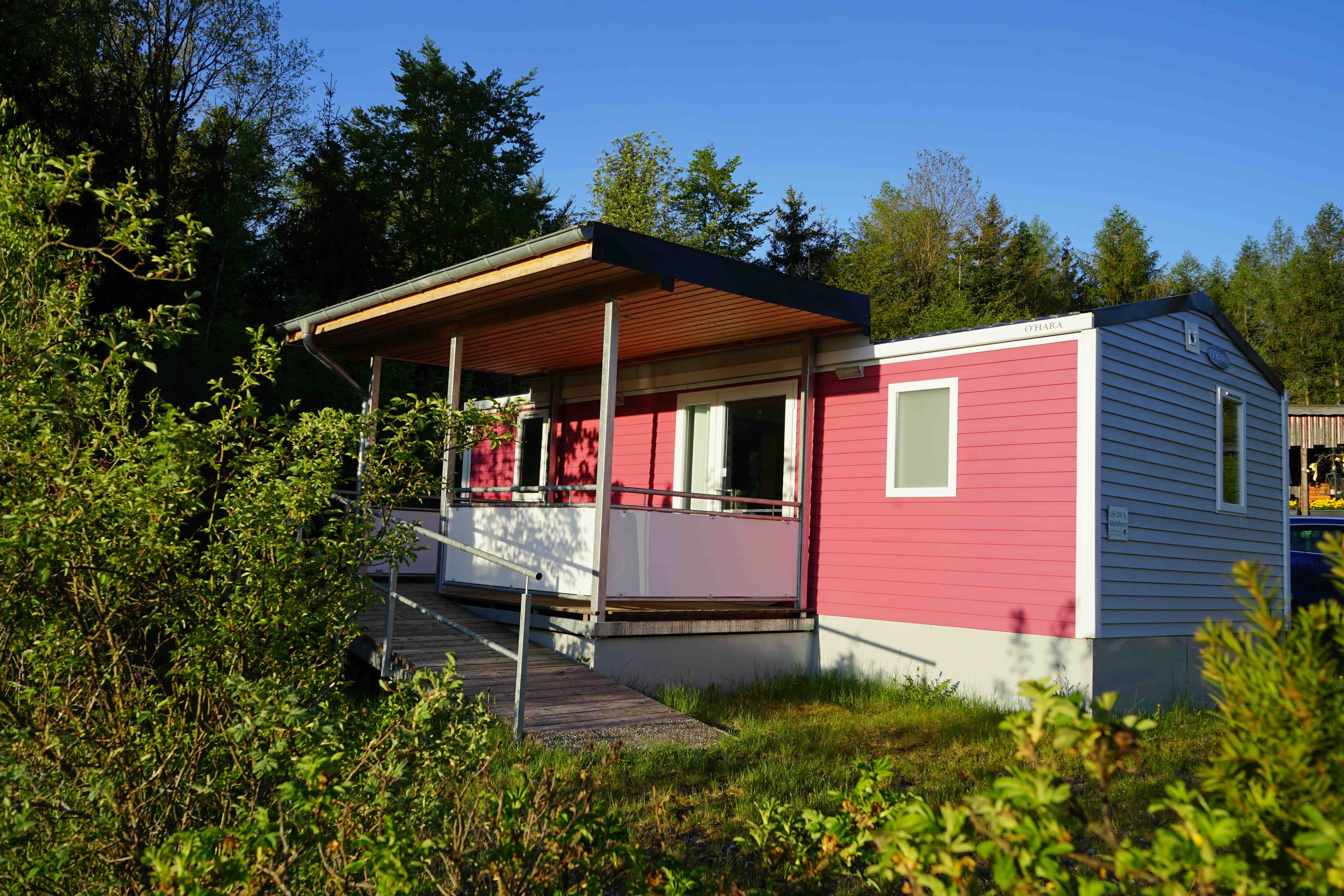 pink mobile home in the green
