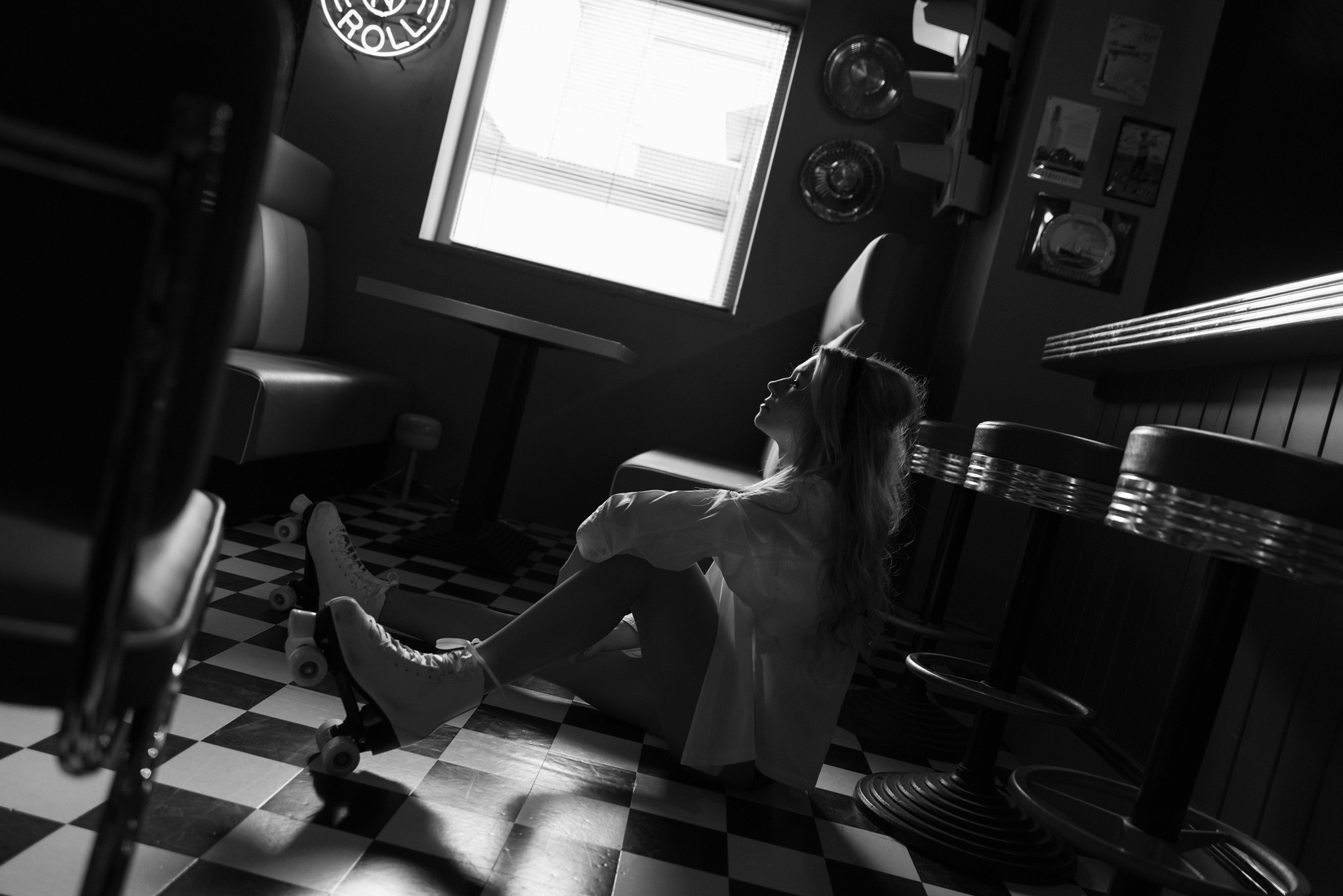 Agnieszka Czyzkowska fine art photography Warsaw woman on floor roller skates head back diner black and white