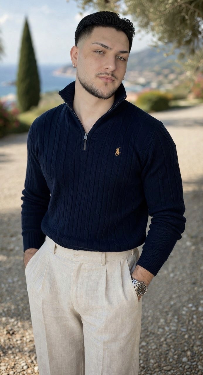 A smiling man holds a basket of cleaning supplies against a light green background.