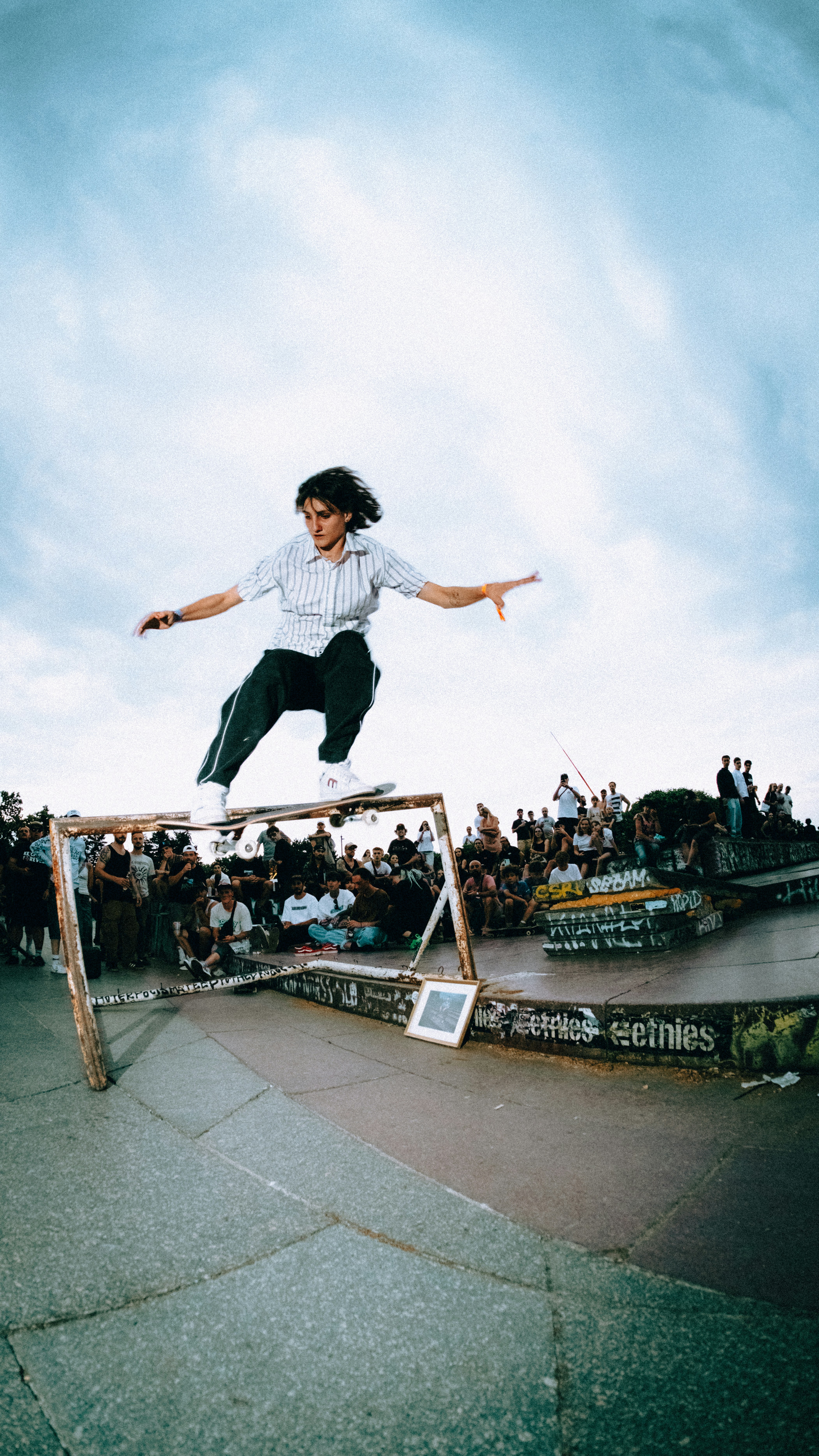 A skateboarder performing a trick on a rail.