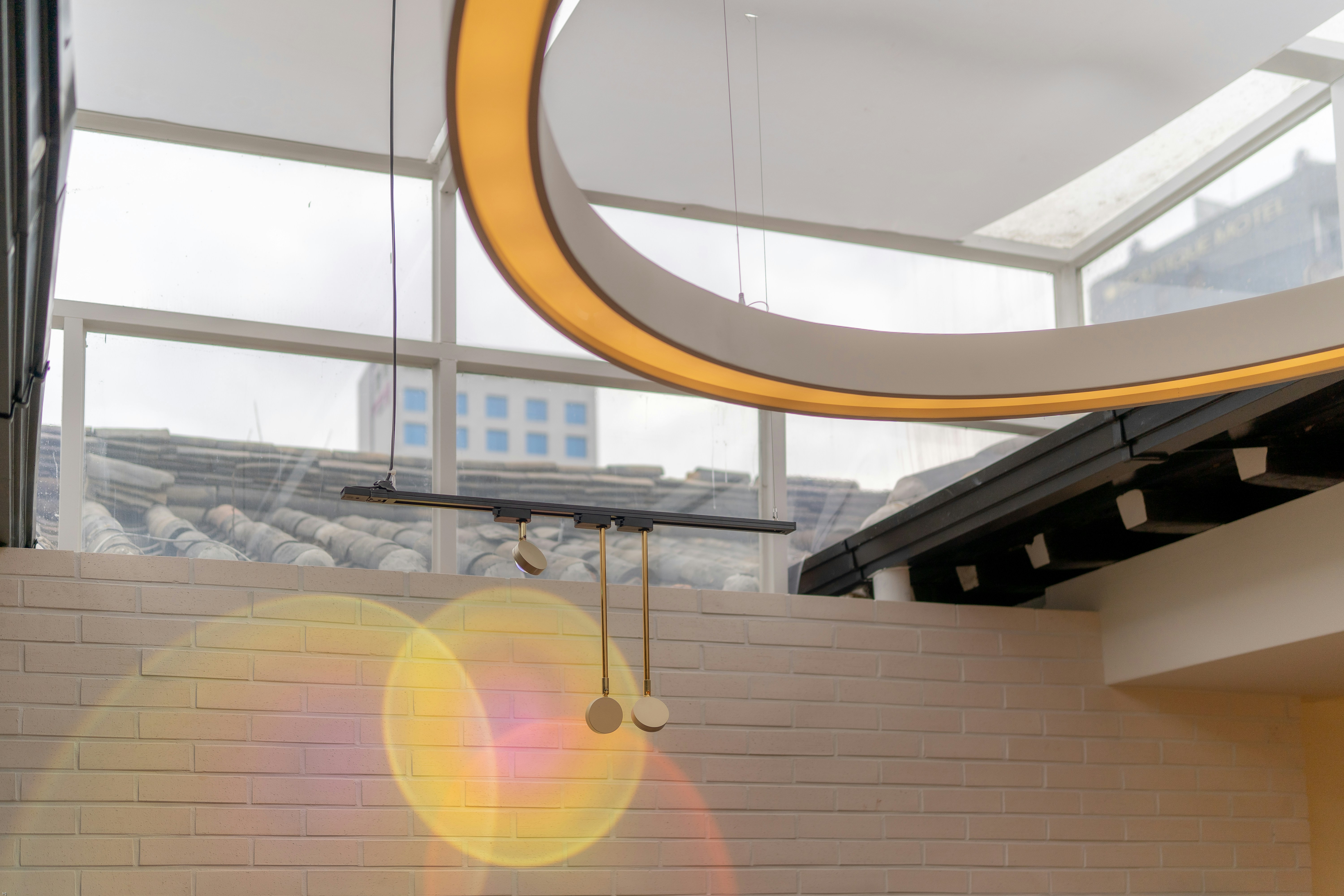 a clock hanging from the ceiling of a building