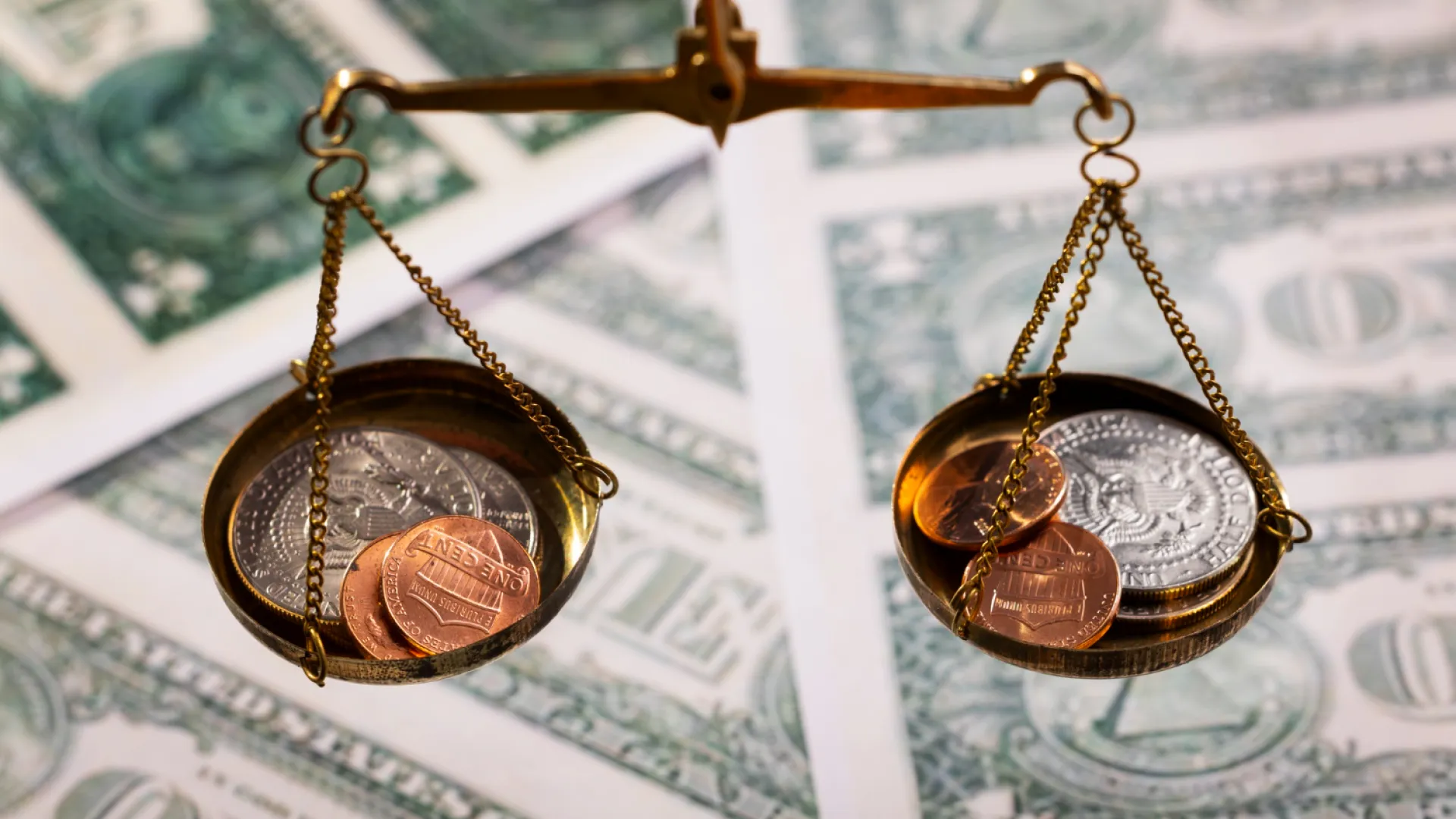 A scale balancing coins over money, symbolizing the risk of withheld payouts from TikTok Shop IP violations.