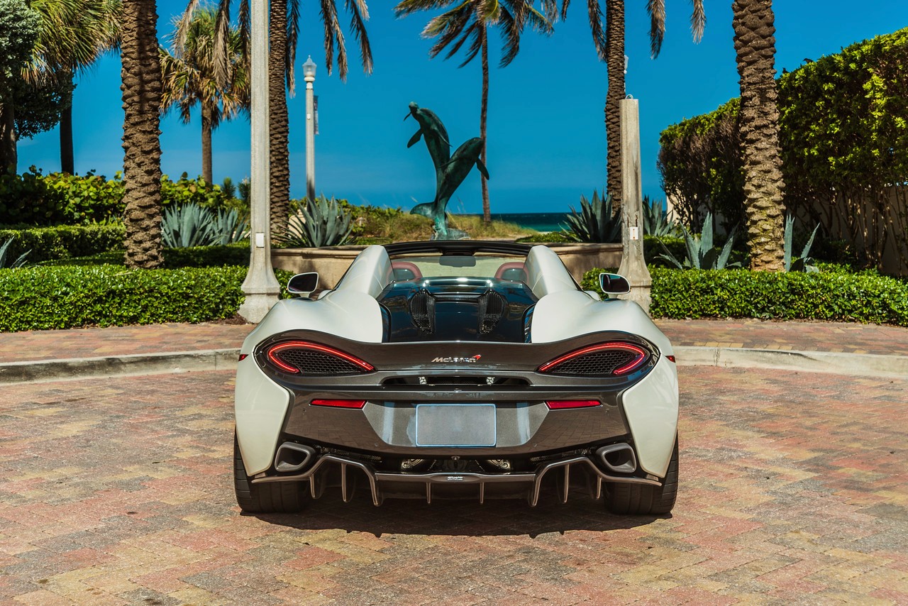 Front-facing shot of the McLaren 570S, emphasizing the aggressive front bumper, sharp LED headlights, and signature McLaren styling.