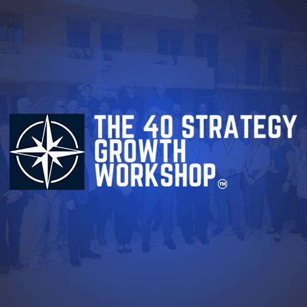 Two men reviewing documents together by a large window, with sunlight streaming in.