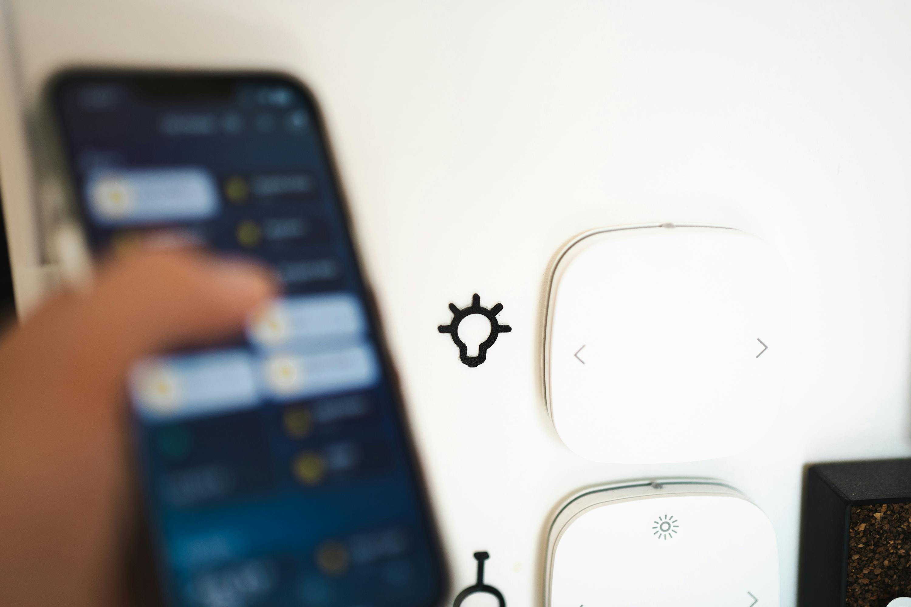 Smart home interface on phone and wall controls.