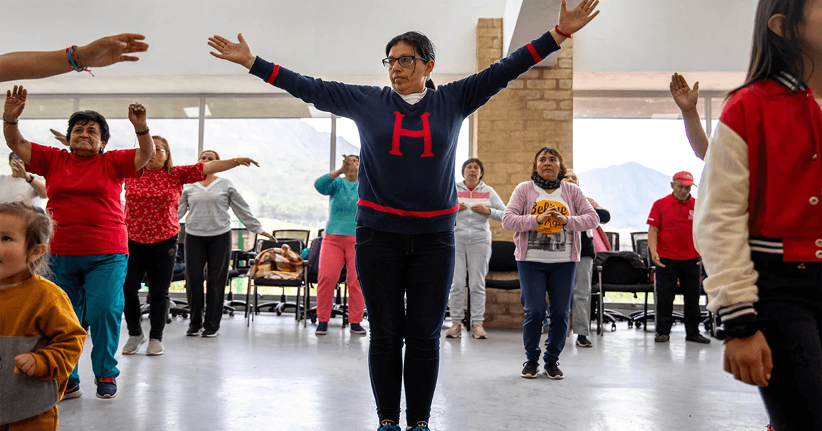 Woman "standing center, has been a full-time family caregiver for nearly a decade. She says that the dance and cardio classes are the only chance she has to exercise and meet other caregivers in the community.