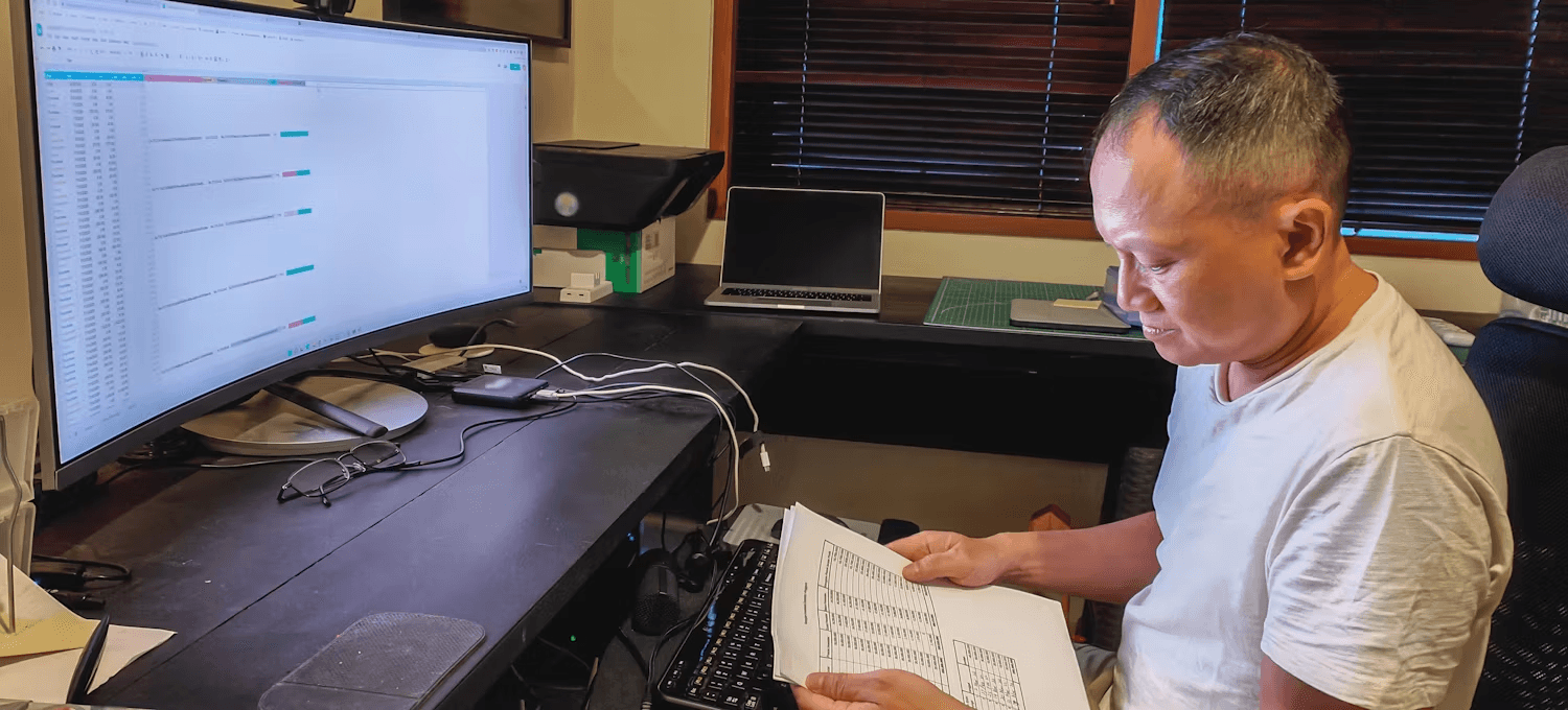 Man reviews spreadsheet paperwork - How to Categorize Data Based on Values in Excel