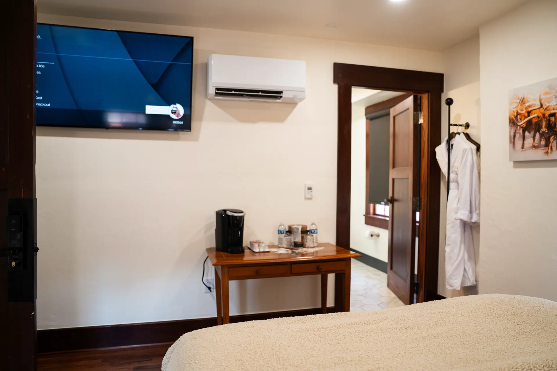 Coffee station, TV, robe and bathroom entrance