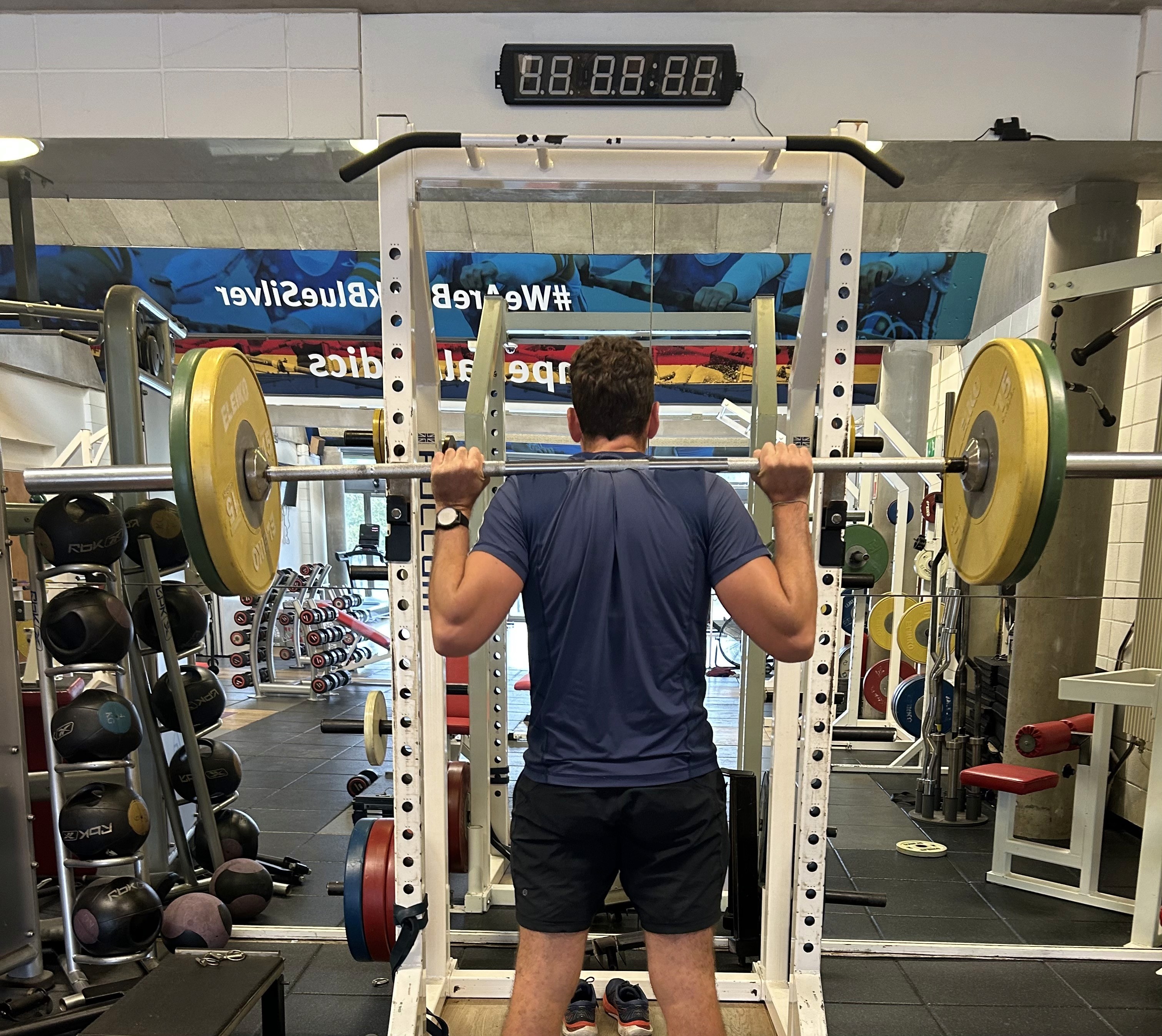 Man doing squats in a gym